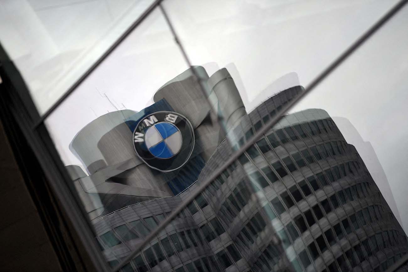 FILE PHOTO: The logo of German car manufacturer BMW is reflected in a window at the company headquarters in Munich, Germany, May 14, 2020. REUTERS