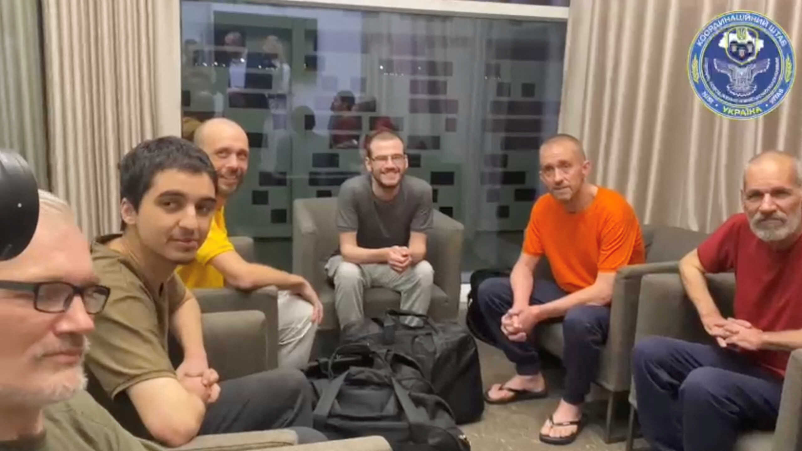 Prisoners of war (POWs) sit after a swap, amid Russia's attack on Ukraine, in a location given as Riyadh, Saudi Arabia, in this screen grab taken from a handout video September 21, 2022. Coordination Headquarters for Treatment of Prisoners of War