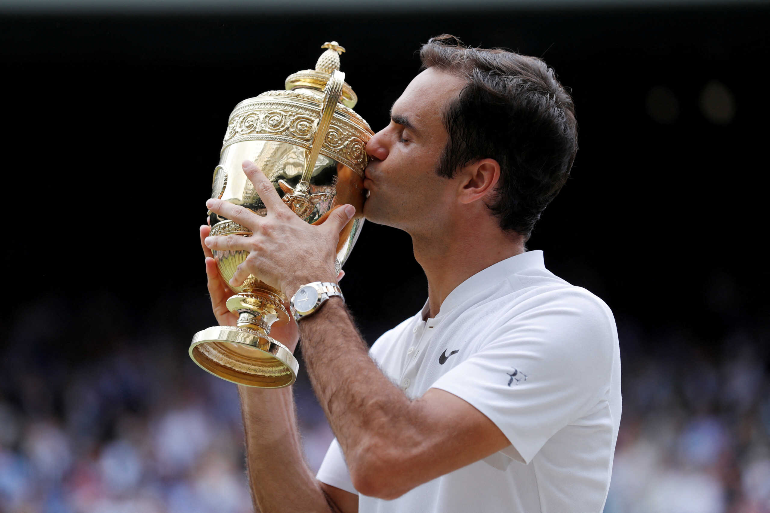 FILE PHOTO: Tennis - Wimbledon - London, Britain - July 16, 2017   Switzerland’s Roger Federer celebrates with the trophy after winning the final against Croatia’s Marin Cilic     REUTERS