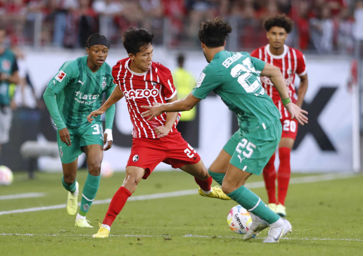 Soccer Football - Bundesliga - SC Freiburg v Borussia Moenchengladbach - Europa Park Stadion, Freiburg, Germany - September 11, 2022 SC Freiburg's Jeong Woo-yeong in action with Borussia Moenchengladbach's Ramy Bensebaini REUTERS