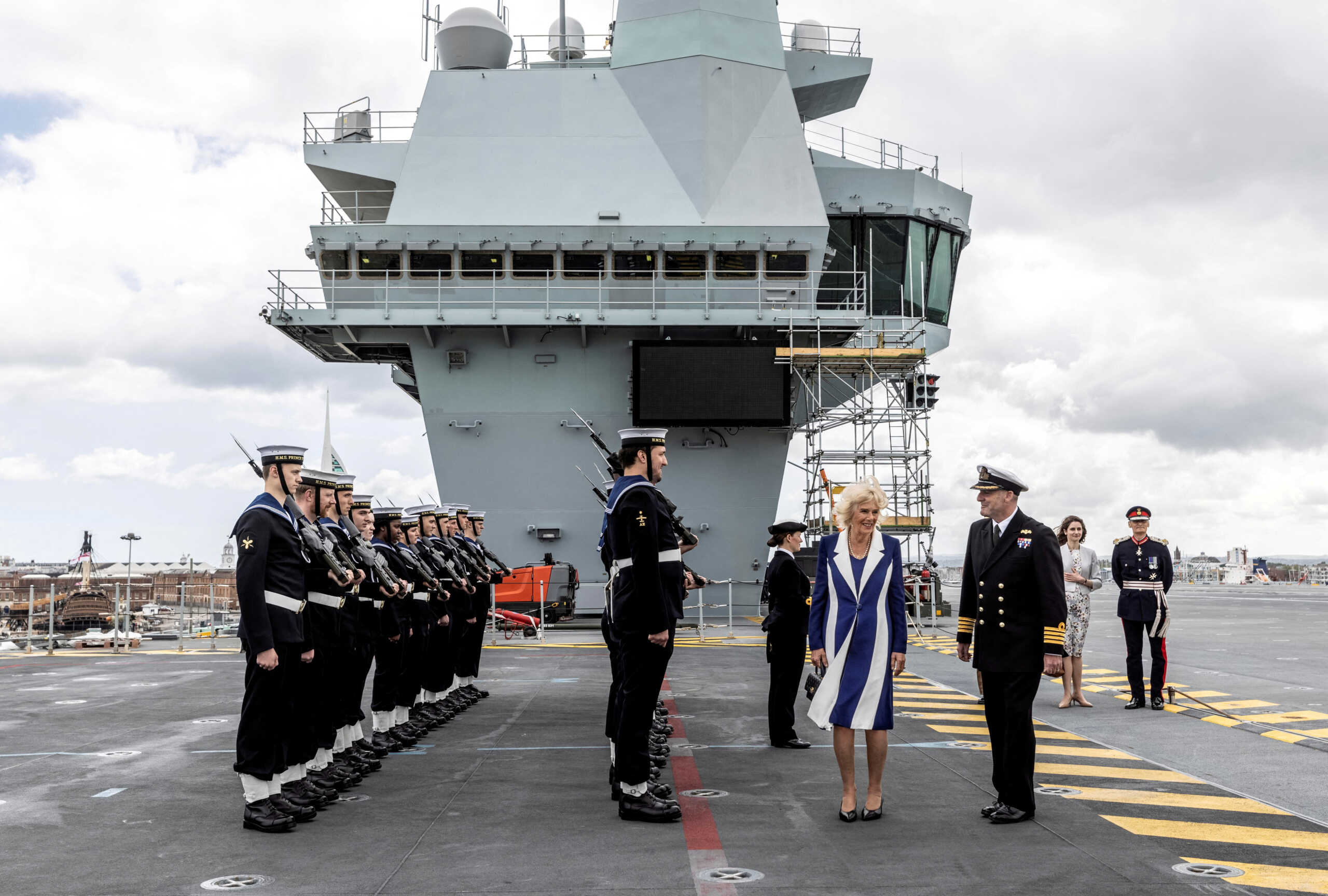 FILE PHOTO: Britain's Camilla, Duchess of Cornwall, is greeted by a guard of honour as she arrives on aircraft carrier HMS Prince of Wales at the Naval Base in Portsmouth before it deploys to the Mediterranean as the flagship for the NATO Response Force Task Group, in Portsmouth, Britain May 12, 2022. Richard Pohle