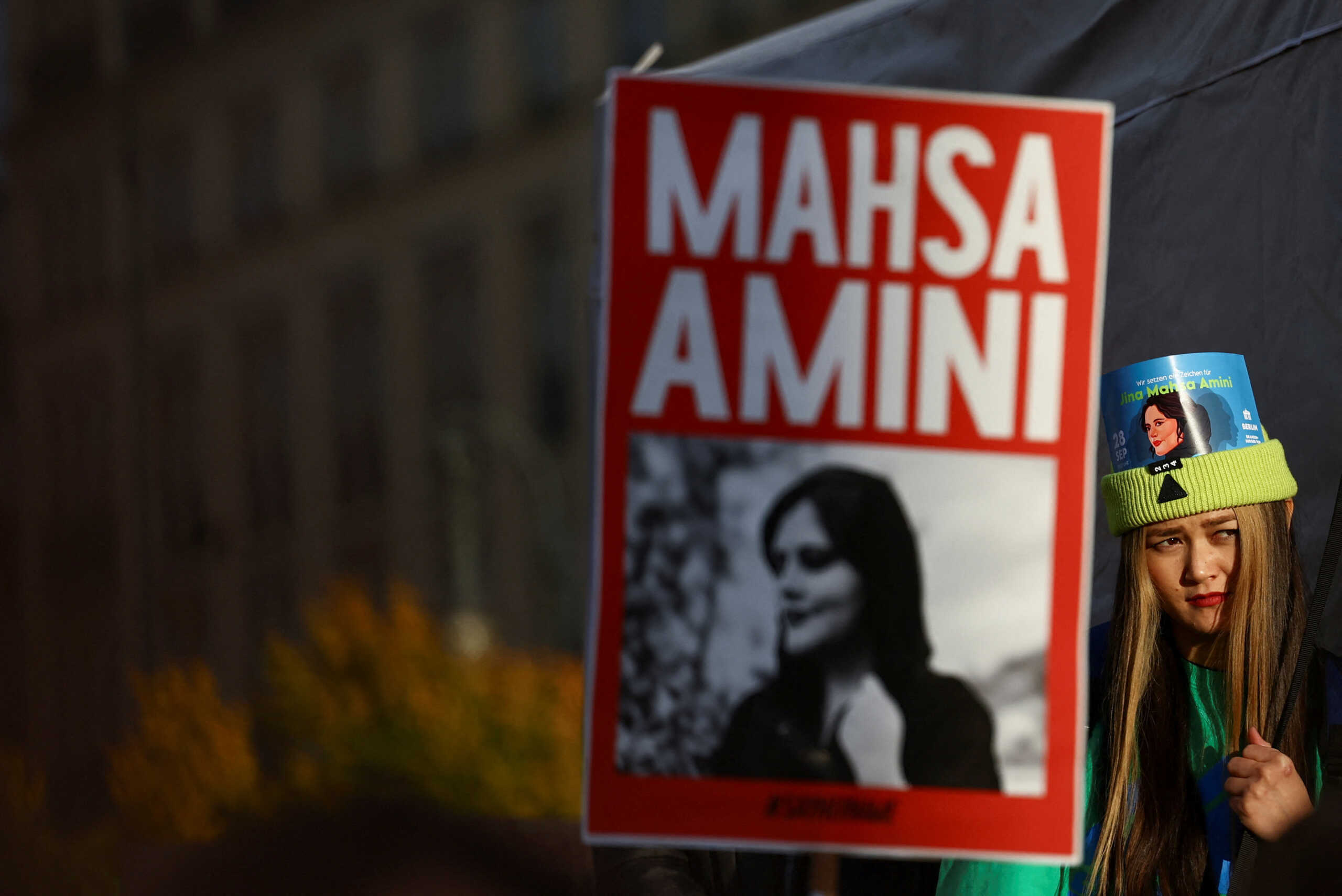 A demonstrator looks on during a protest following the death of Mahsa Amini in Iran, near the Brandenburg Gate, in Berlin, Germany, September 28, 2022. REUTERS