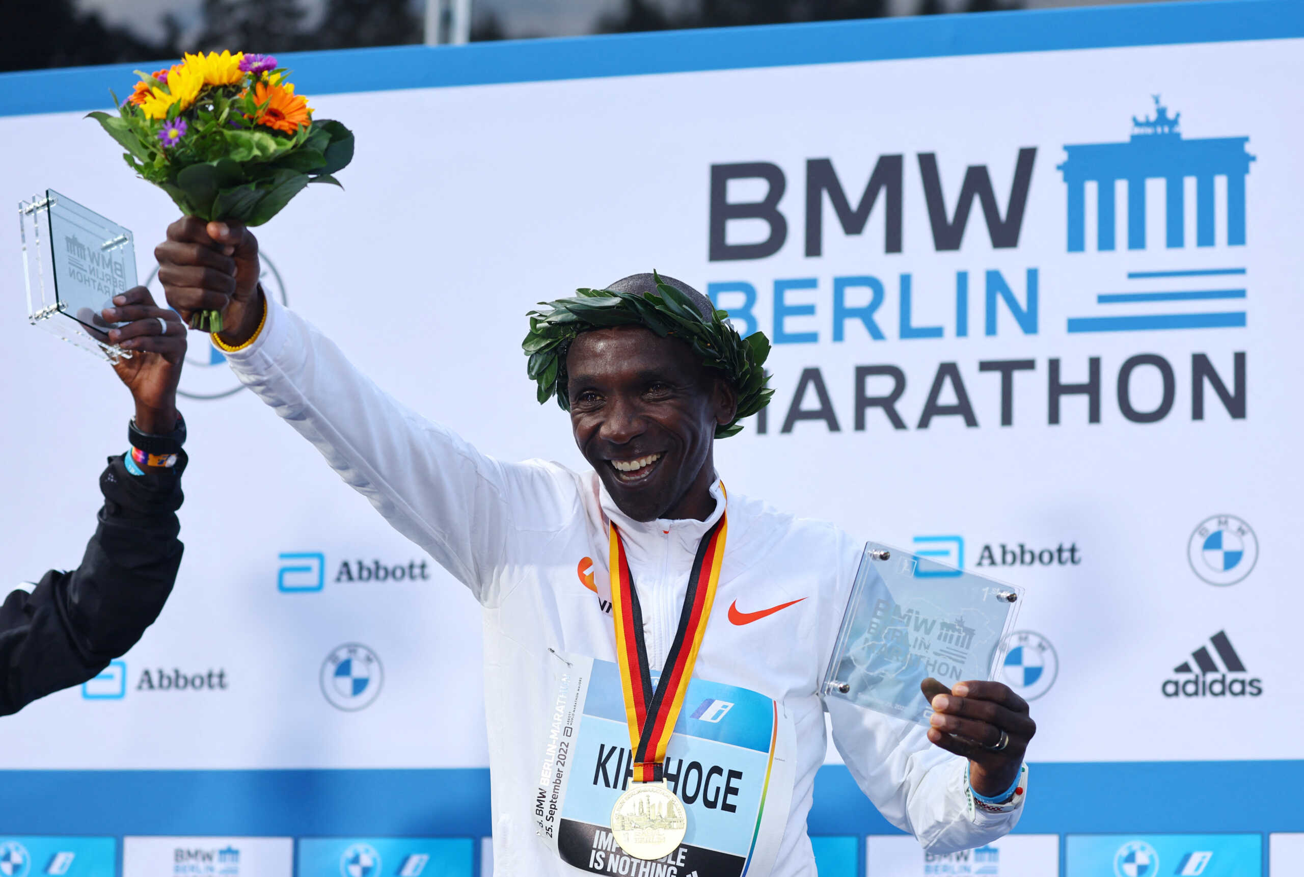 Athletics - Berlin Marathon - Berlin, Germany - September 25, 2022 Kenya's Eliud Kipchoge celebrates om the podium with trophy after winning the Berlin Marathon and breaking the World Record REUTERS