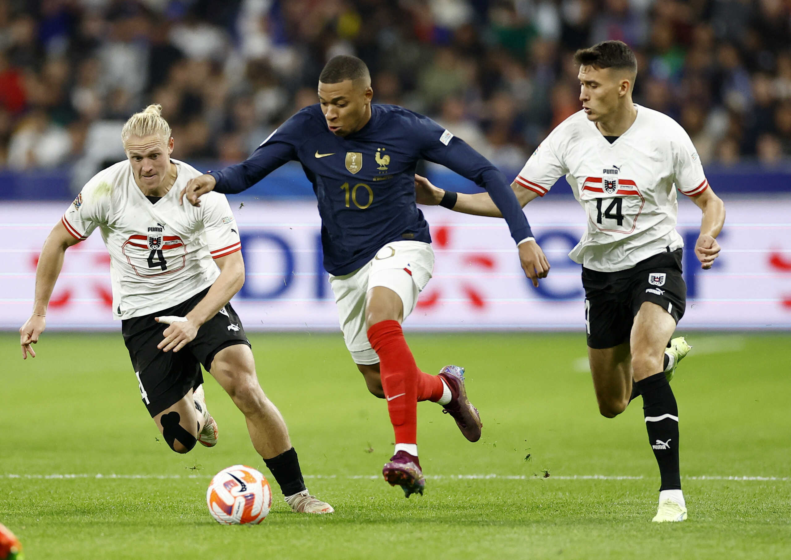Soccer Football - UEFA Nations League - Group A - France v Austria - Stade de France, Saint-Denis, France - September 22, 2022   France's Kylian Mbappe in action with Austria's Dejan Ljubicic and Xaver Schlager REUTERS