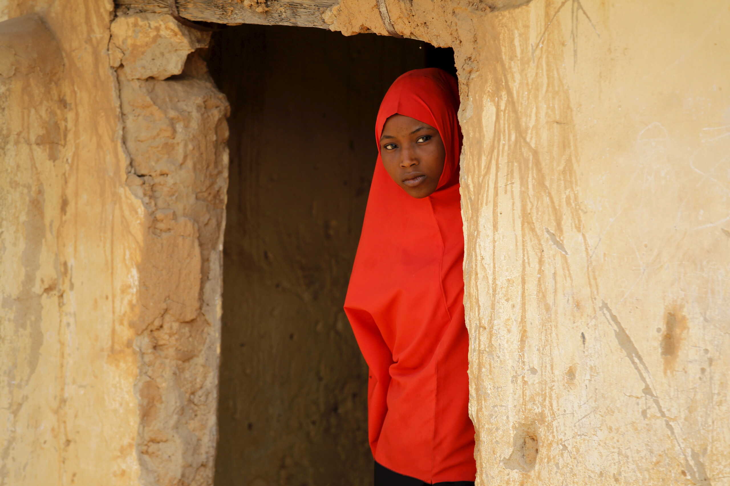 FILE PHOTO: A girl peers out of a doorway at a local Islamic school in Zaria, Kaduna state, Nigeria, February 2, 2016. REUTERS