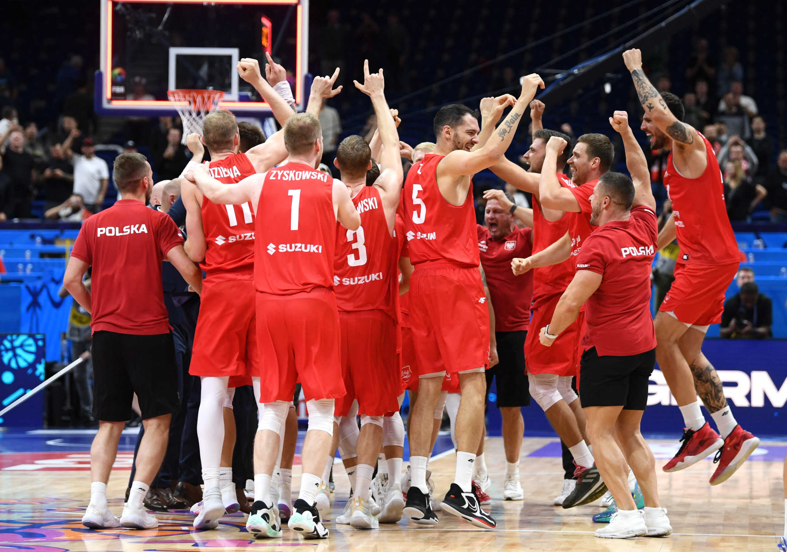 Basketball - EuroBasket Championship - Quarter Final - Slovenia v Poland - Mercedes-Benz Arena, Berlin, Germany - September 14, 2022  Poland players and coaches celebrate after the match REUTERS