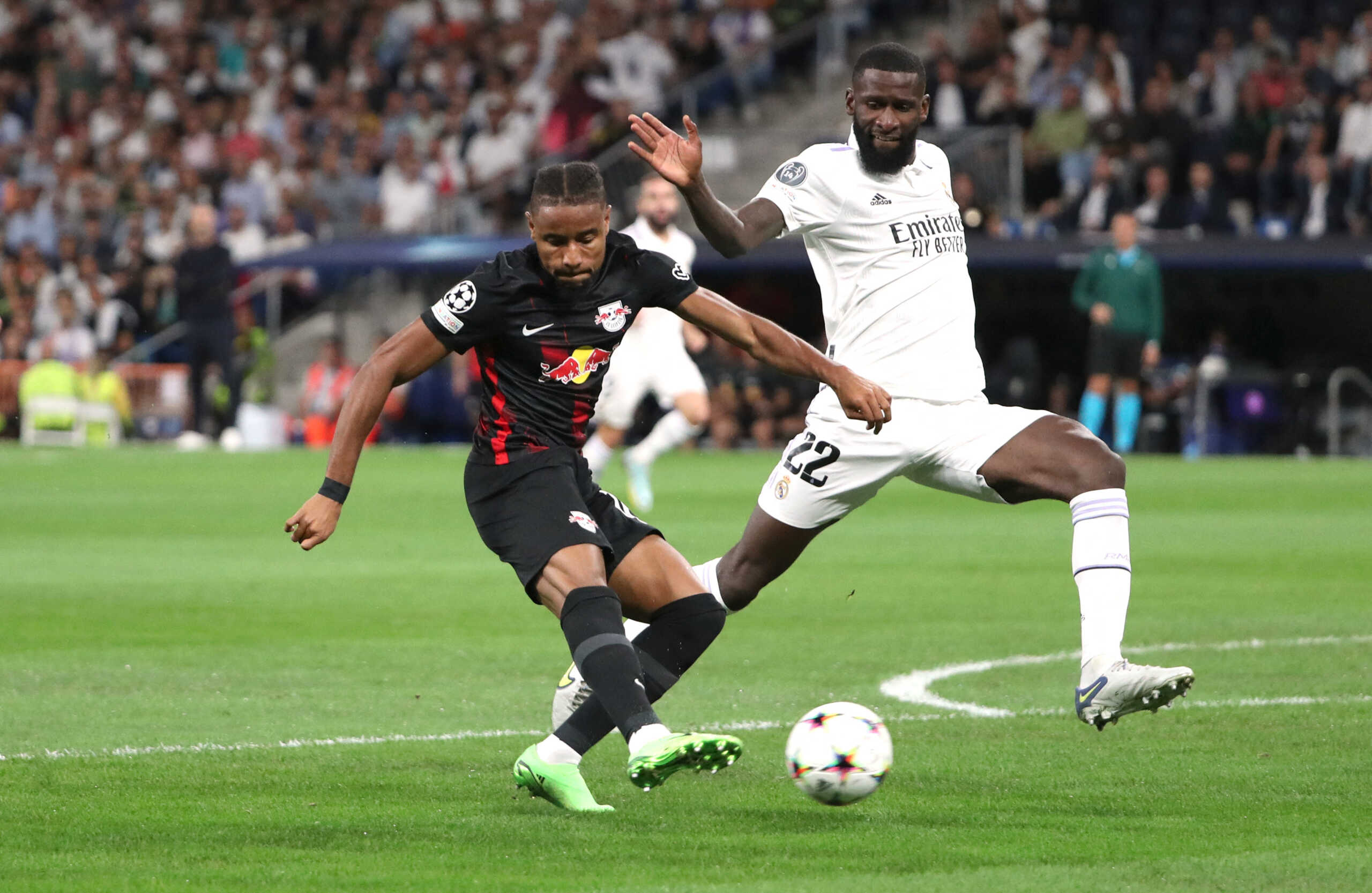 Soccer Football - Champions League - Group F - Real Madrid v RB Leipzig - Santiago Bernabeu, Madrid, Spain - September 14, 2022 RB Leipzig's Christopher Nkunku in action with Real Madrid's Antonio Rudiger REUTERS