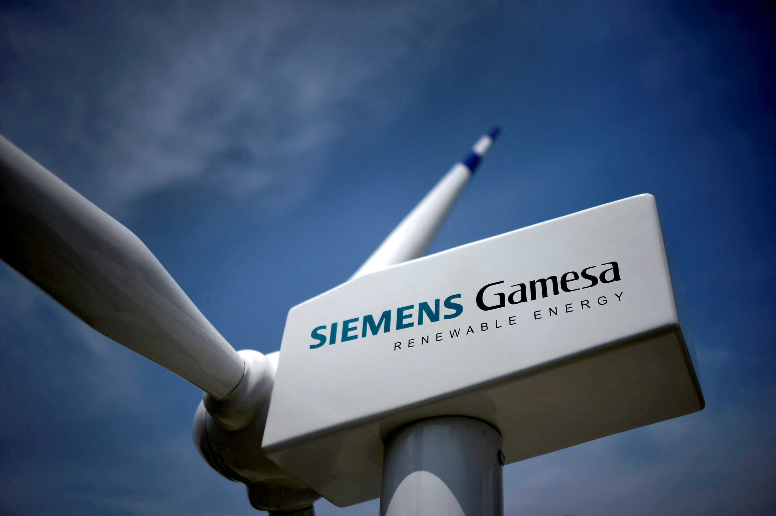 FILE PHOTO: A model of a wind turbine with the Siemens Gamesa logo is displayed outside the annual general shareholders meeting in Zamudio, Spain, June 20, 2017. REUTERS