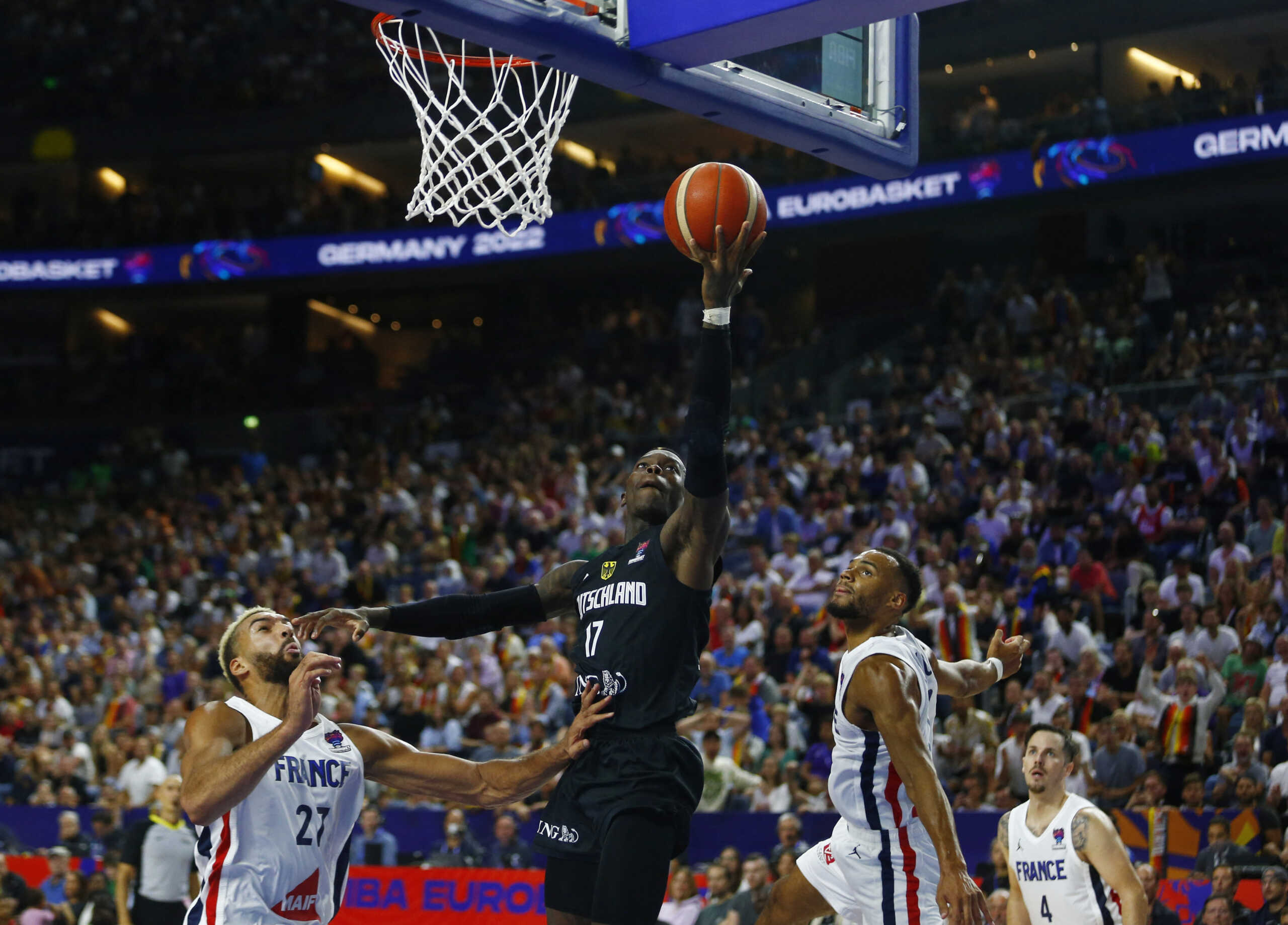 Basketball - EuroBasket Championship - Group B - France v Germany - Cologne Arena, Cologne, Germany - September 1, 2022  Germany's Dennis Schroder in action with France's Rudy Gobert REUTERS