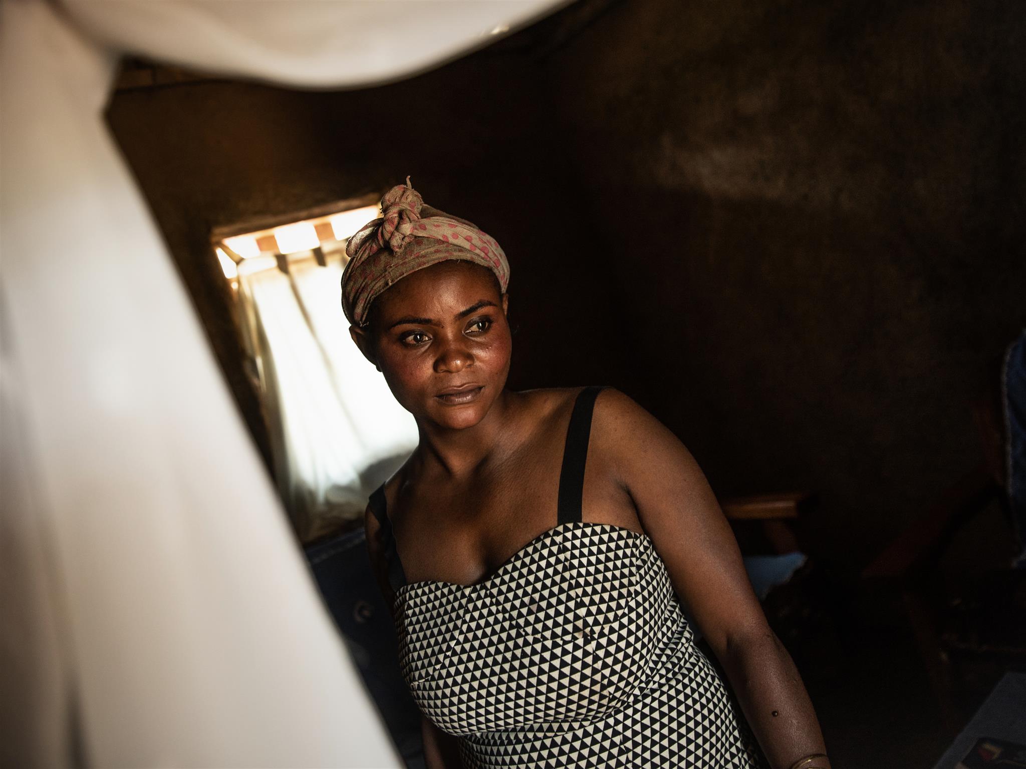 Dekila Kavira Kyakimwa, 29, poses for a portrait at her home in the town of Mangina, Democratic Republic of Congo, October 15, 2021. Thomson Reuters Foundation