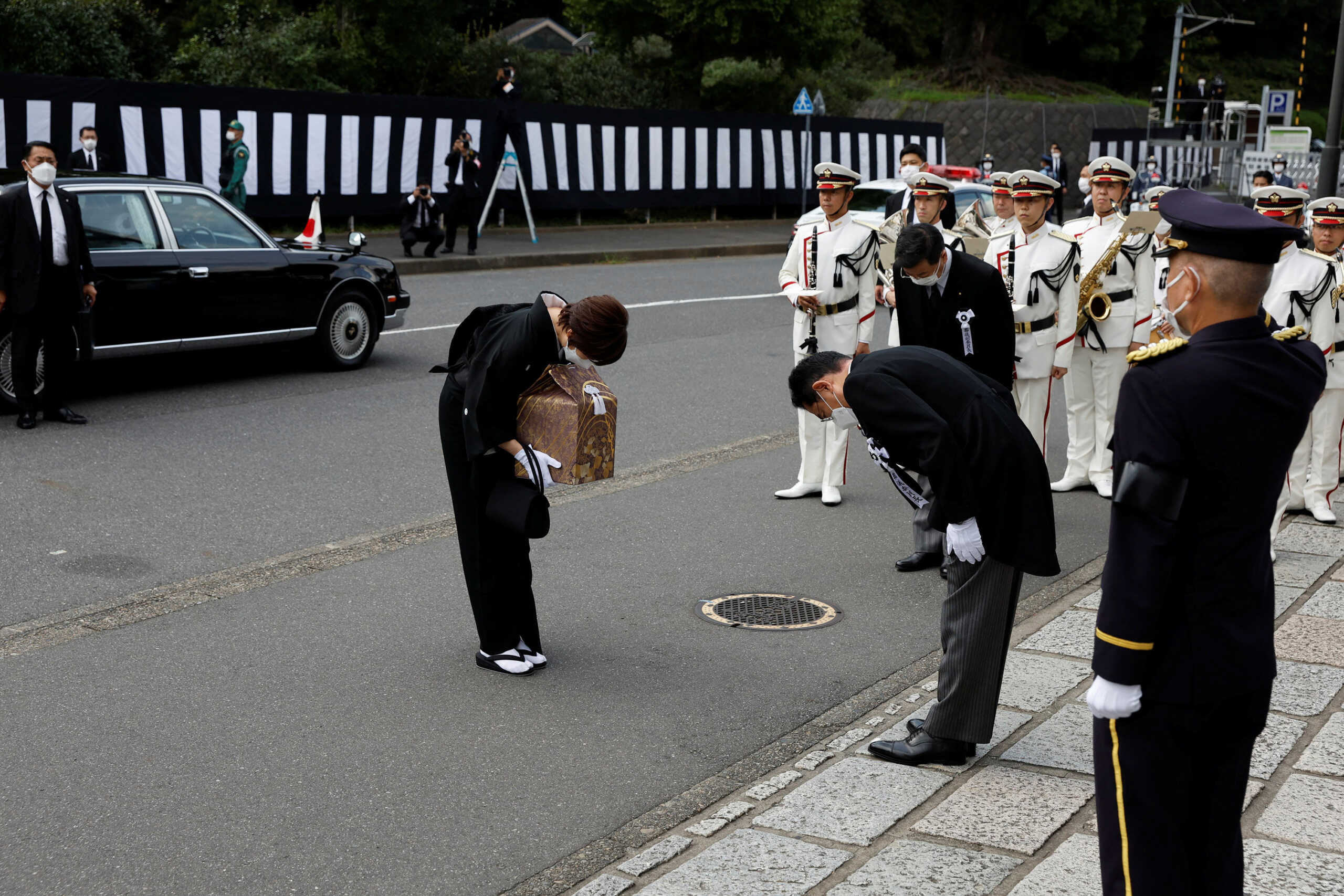 Akie Abe, wife of former Prime Minister Sinzo Abe, bows to Fumio Kishida, Japan's primes minister, as she arrives at the state of funeral of her husband at the Nippon Budokan in Tokyo, Japan, on Tuesday, Sept. 27, 2022. Kiyoshi Ota