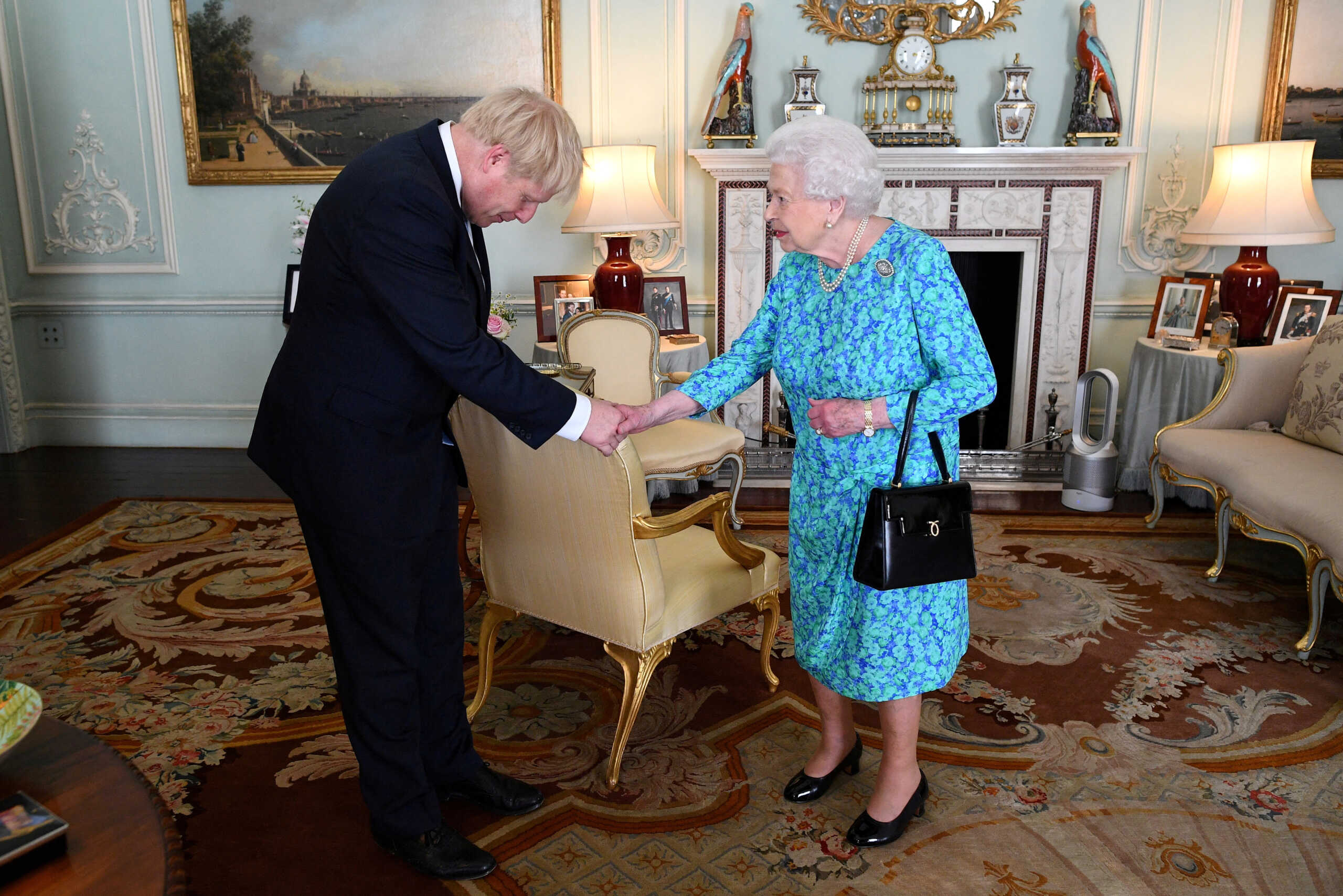 FILE PHOTO: Queen Elizabeth II welcomes Boris Johnson during an audience in Buckingham Palace, where she officially recognised him as the new Prime Minister, in London, Britain July 24, 2019. Victoria Jones