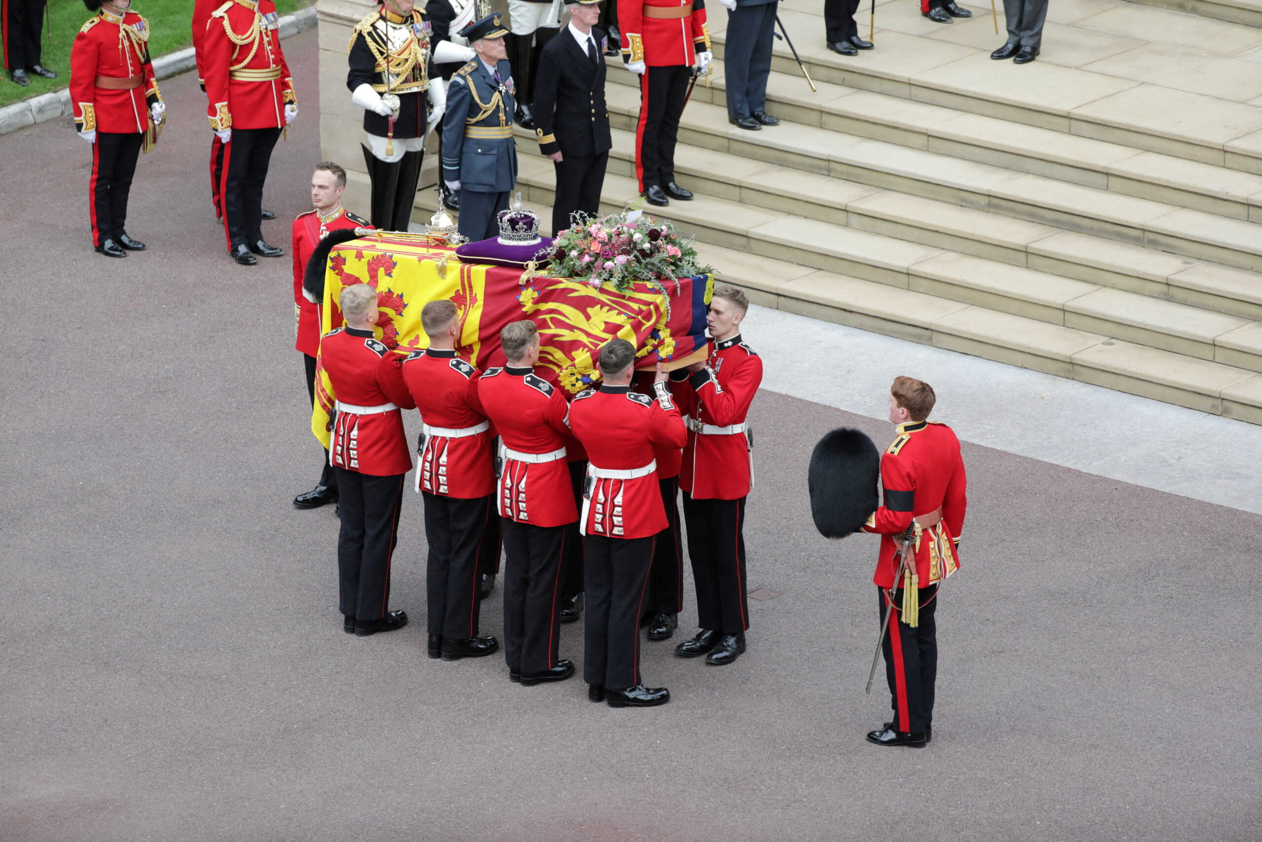 The coffin of Her Majesty Queen Elizabeth II, is seen here entering St George VI Chapel at Windsor Castle, September 19, 2022.  The UK Armed Forces have played a part in the procession for Her Majesty The Queen’s funeral and committal service today, in London and Windsor.   Marking the end to 10 days of proceedings, service personnel representing a variety of regiments, ships and air stations that held a special relationship with Her Majesty The Queen took part in the funeral processions in London and Windsor. Around 4,000 regular and reserve soldiers, sailors, marines and aviators, as well as musicians from Armed Forces bands, took part in the proceedings today.   This included over 3,000 military personnel in central London, with 1,650 personnel forming part of the procession from the Palace of Westminster to Westminster Abbey and procession from Westminster Abbey to Wellington Arch.   In Windsor, over 1,000 military personnel were involved in ceremonial activity, including 410 taking part in the procession from Albert Road, Windsor, to St George’s Chapel, Windsor Castle.   The proceedings in London saw the Bearer Party, formed of personnel from The Queen’s Company, 1st Battalion The Grenadier Guards, transfer Her Majesty The Queen’s Coffin from Westminster Hall to the State Gun Carriage, which was pulled by 142 Naval Ratings to Westminster Abbey.     PO Phot Dave Jenkins