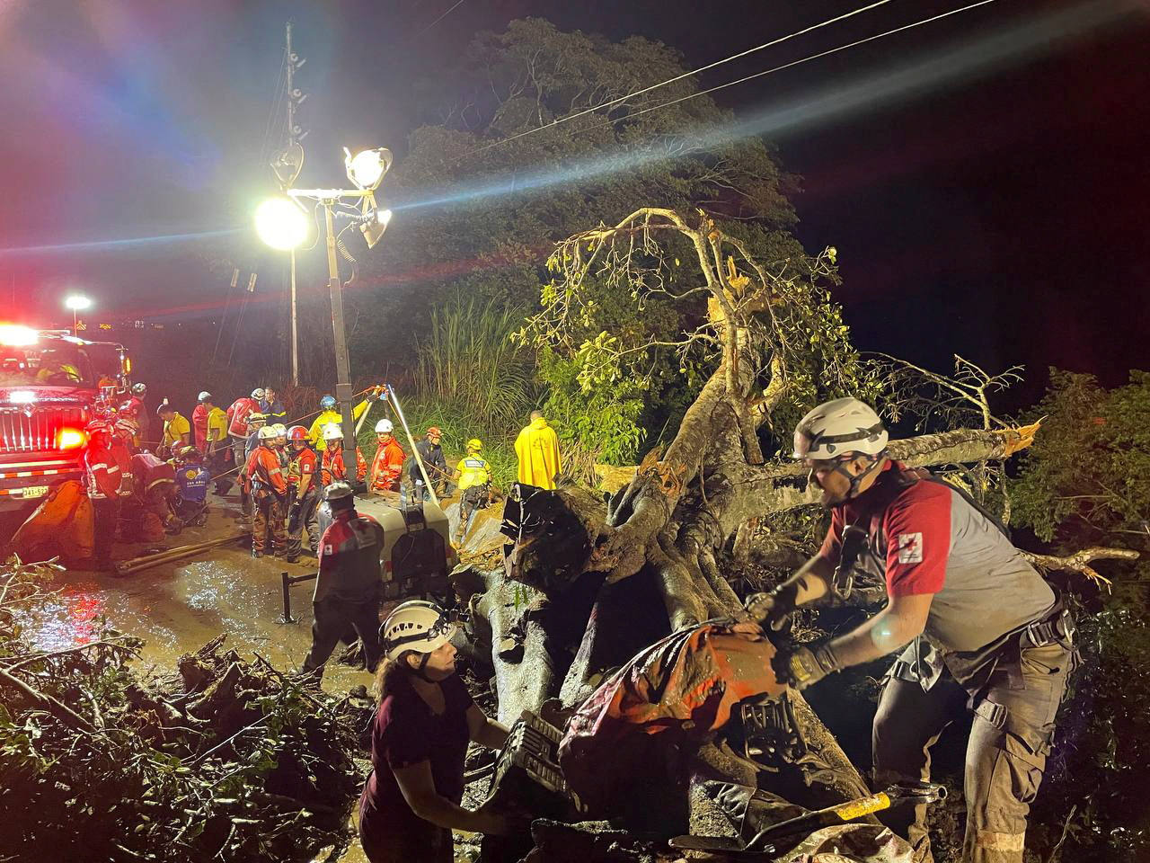 Members of the Red Cross and firefighters work at the scene of a deadly bus accident, where a landslide reportedly hit the vehicle, throwing it off a cliff, in Cambronero, Alajuela Province, Costa Rica in this social media handout image released September 18, 2022. Cruz Roja