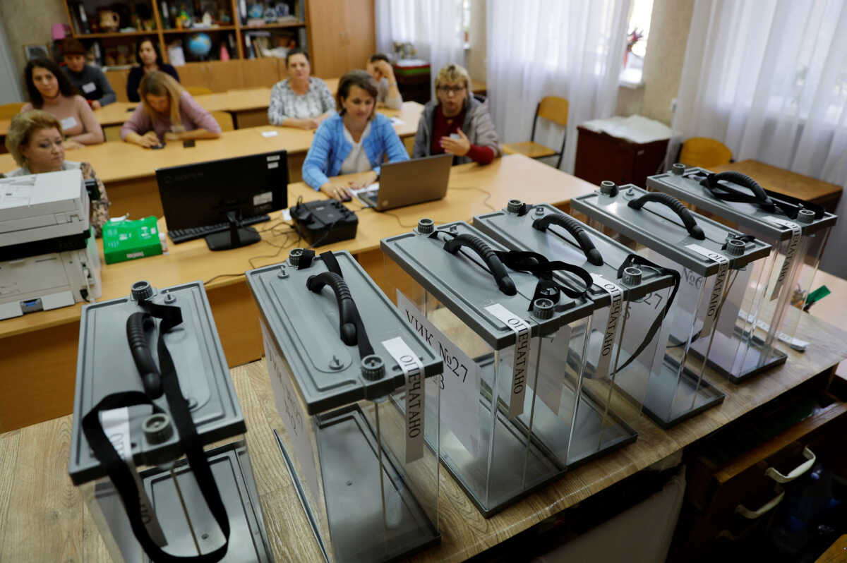 Members of the local electoral commission gather at a polling station ahead of the planned referendum on the joining of the self-proclaimed Donetsk people's republic to Russia, in Donetsk, Ukraine September 22, 2022. REUTERS