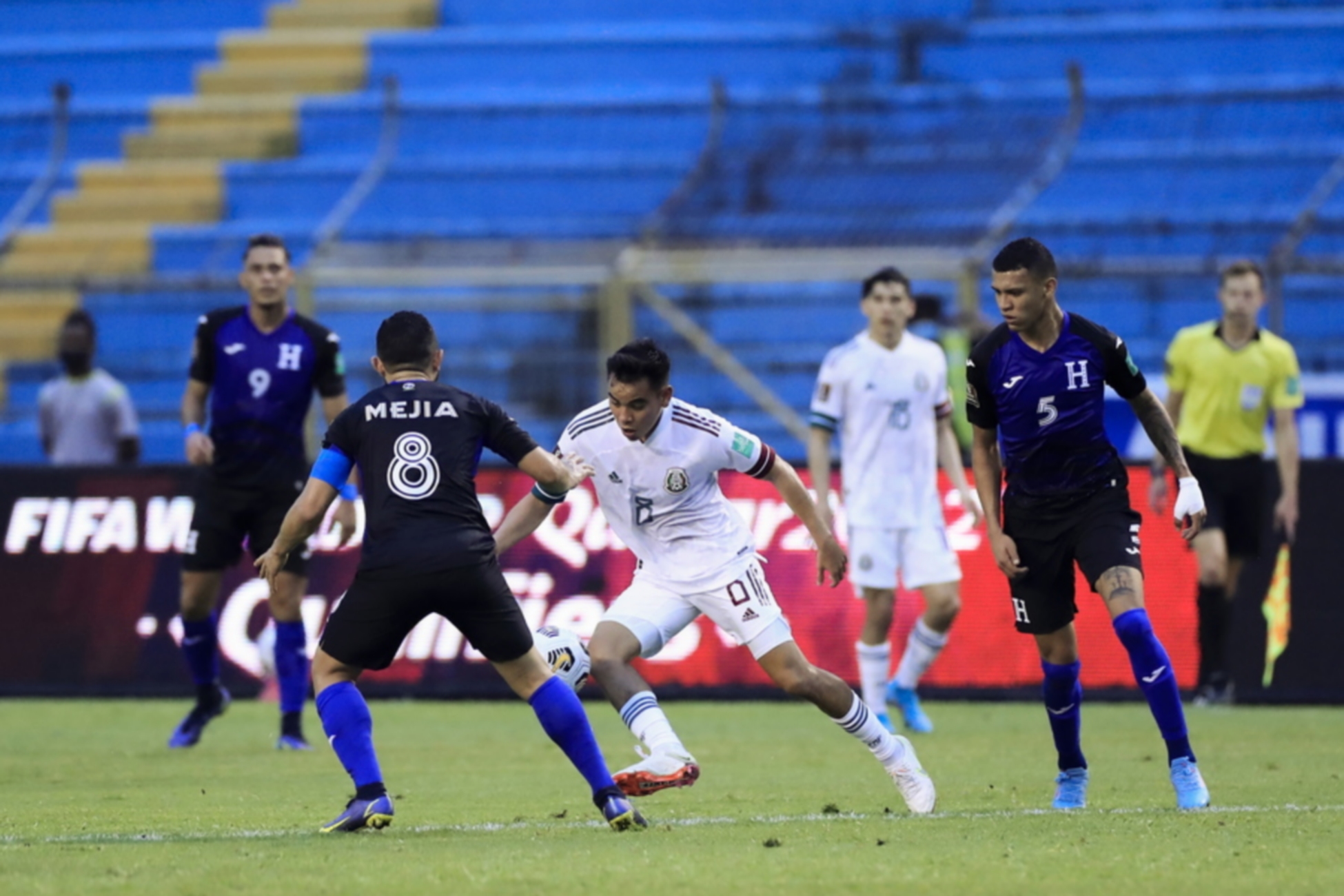 epa09854325 Edwin Rodriguez (L) of Honduras disputes the ball with Carlos Rodriguez (C) of Mexico  during a soccer match of the Concacaf qualifiers for the 2022 Qatar World Cup between Honduras and Mexico at the Metropolitan Olympic Stadium in San Pedro Sula, Honduras, 27 March 2022.  EPA
