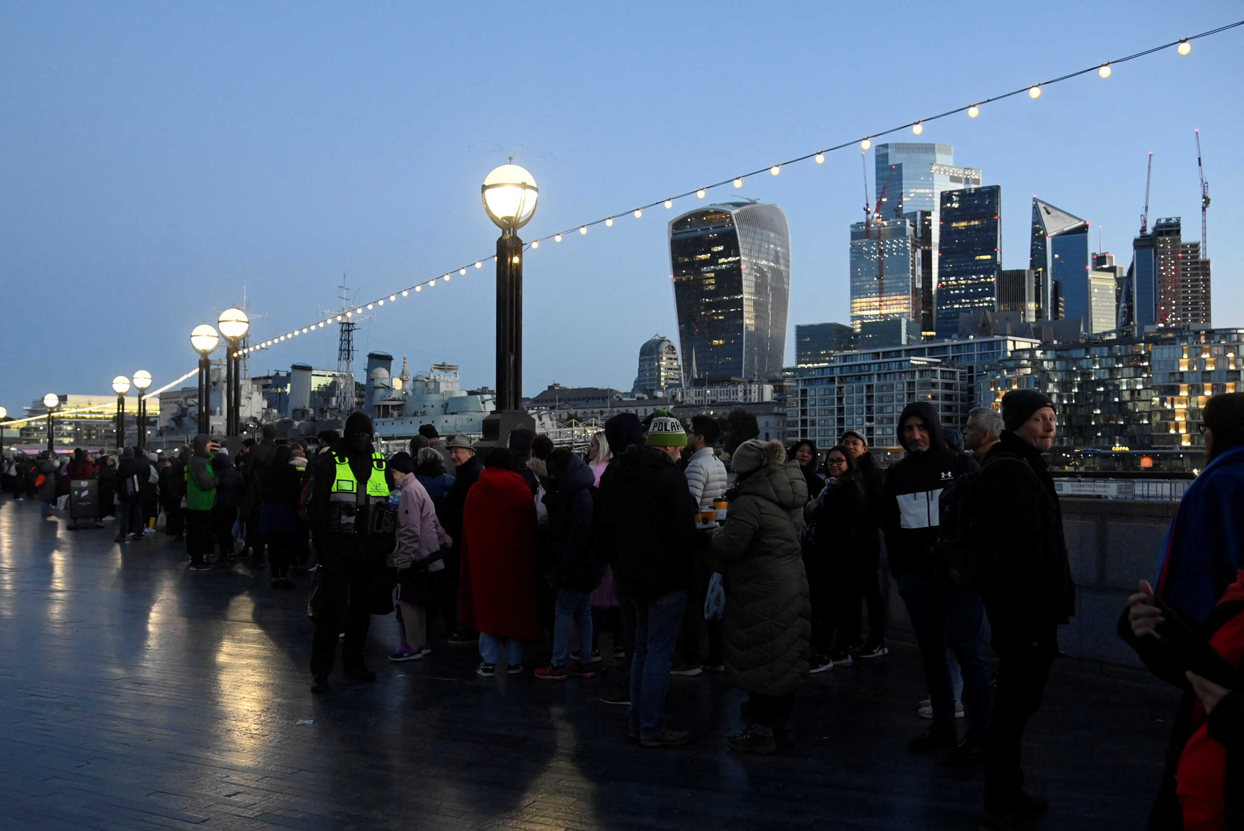 People queue before sunrise to pay their respects to Britain's Queen Elizabeth following her death, in London, Britain, September 17, 2022.  REUTERS