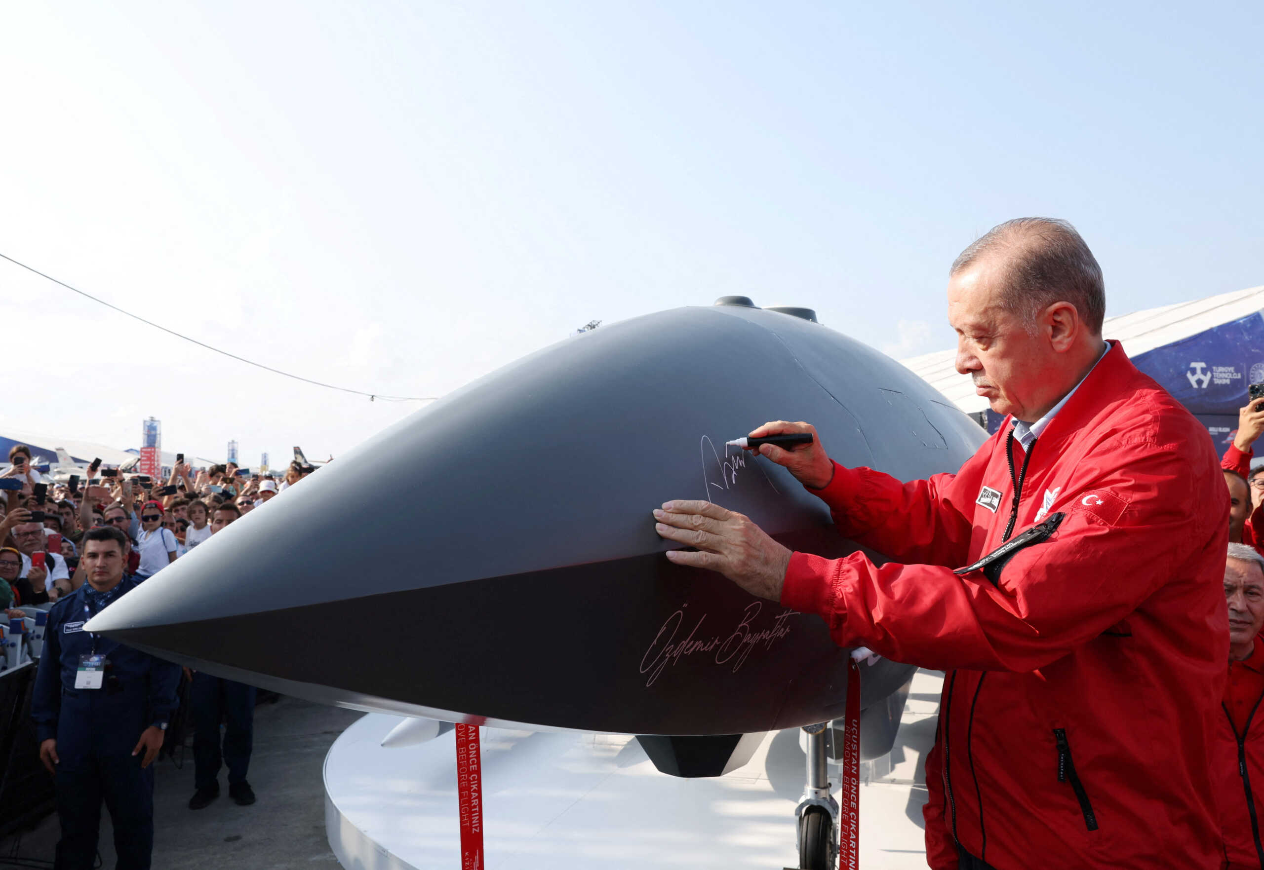 Turkish President Tayyip Erdogan signs Bayraktar Kizilelma, an unmanned combat aircraft, at the Teknofest Black Sea, an aviation, space and technology festival, at Carsamba Airport in Samsun, Turkey September 3, 2022. Murat Cetinmuhurdar
