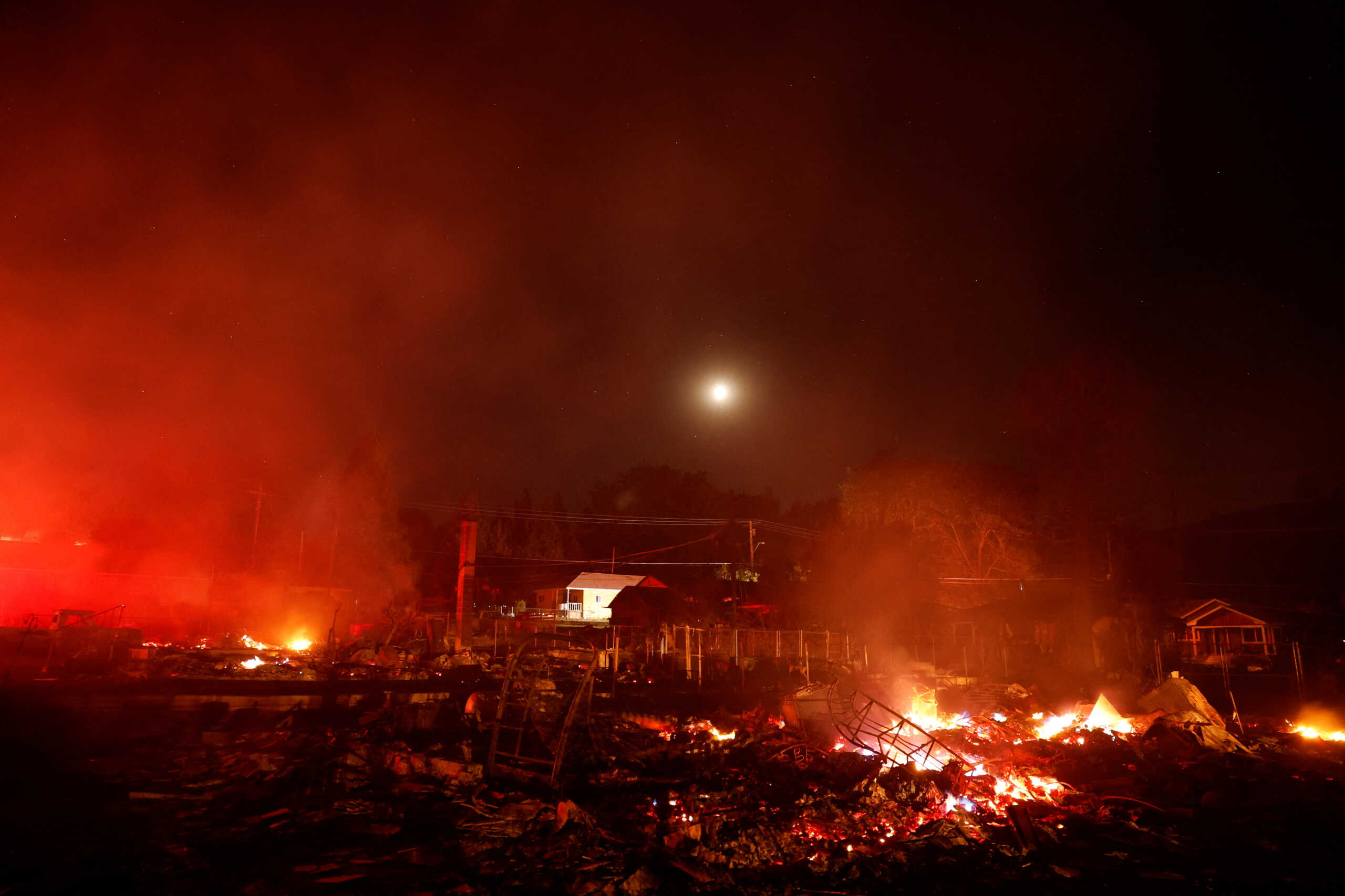 A general view of burnt and burning structures as the Mill Fire burns near Weed, California, U.S., September 2, 2022. REUTERS