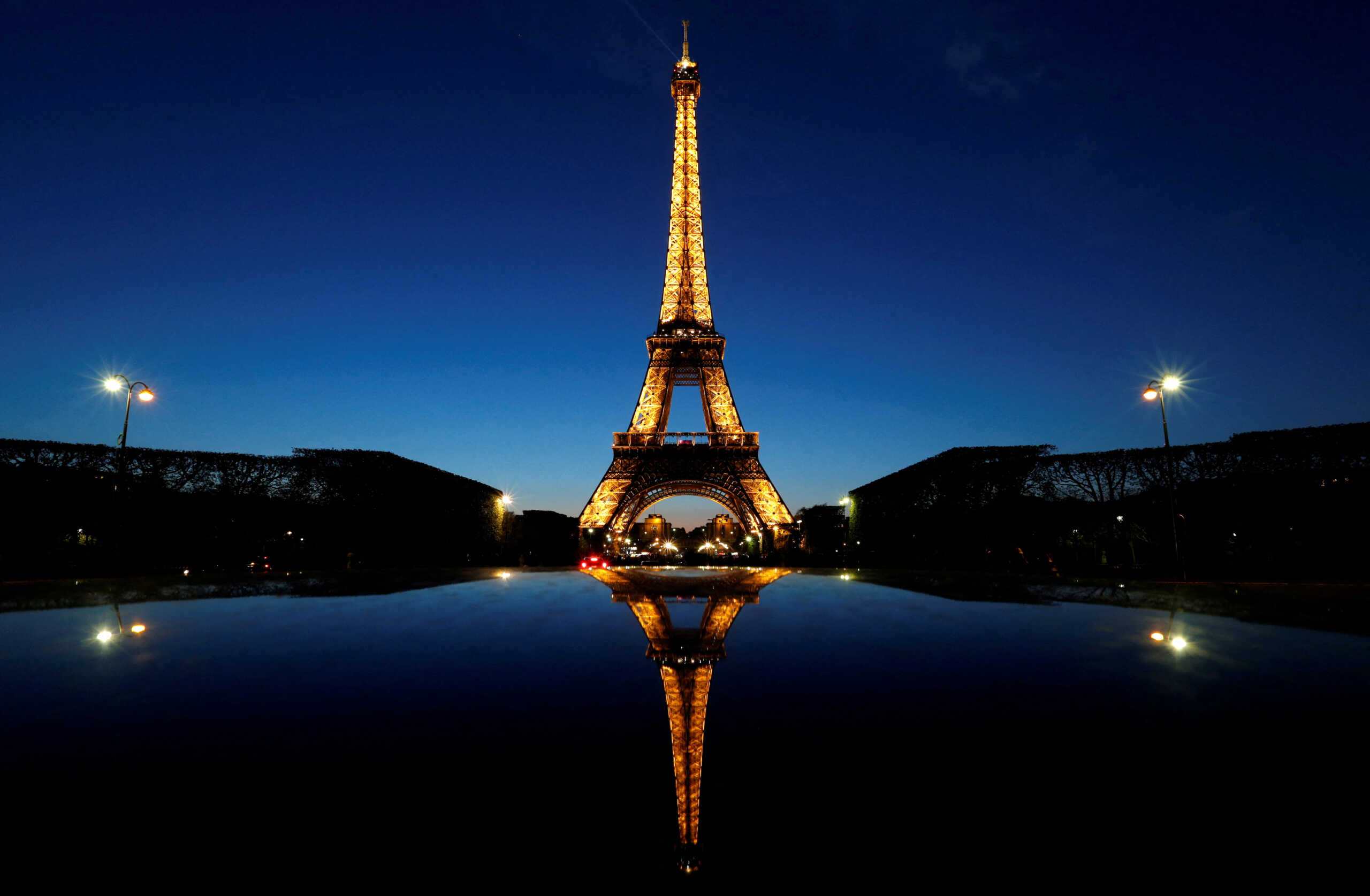 FILE PHOTO: A night view shows the Eiffel tower, reflected in a car's roof, in Paris, France, April 30, 2016. REUTERS