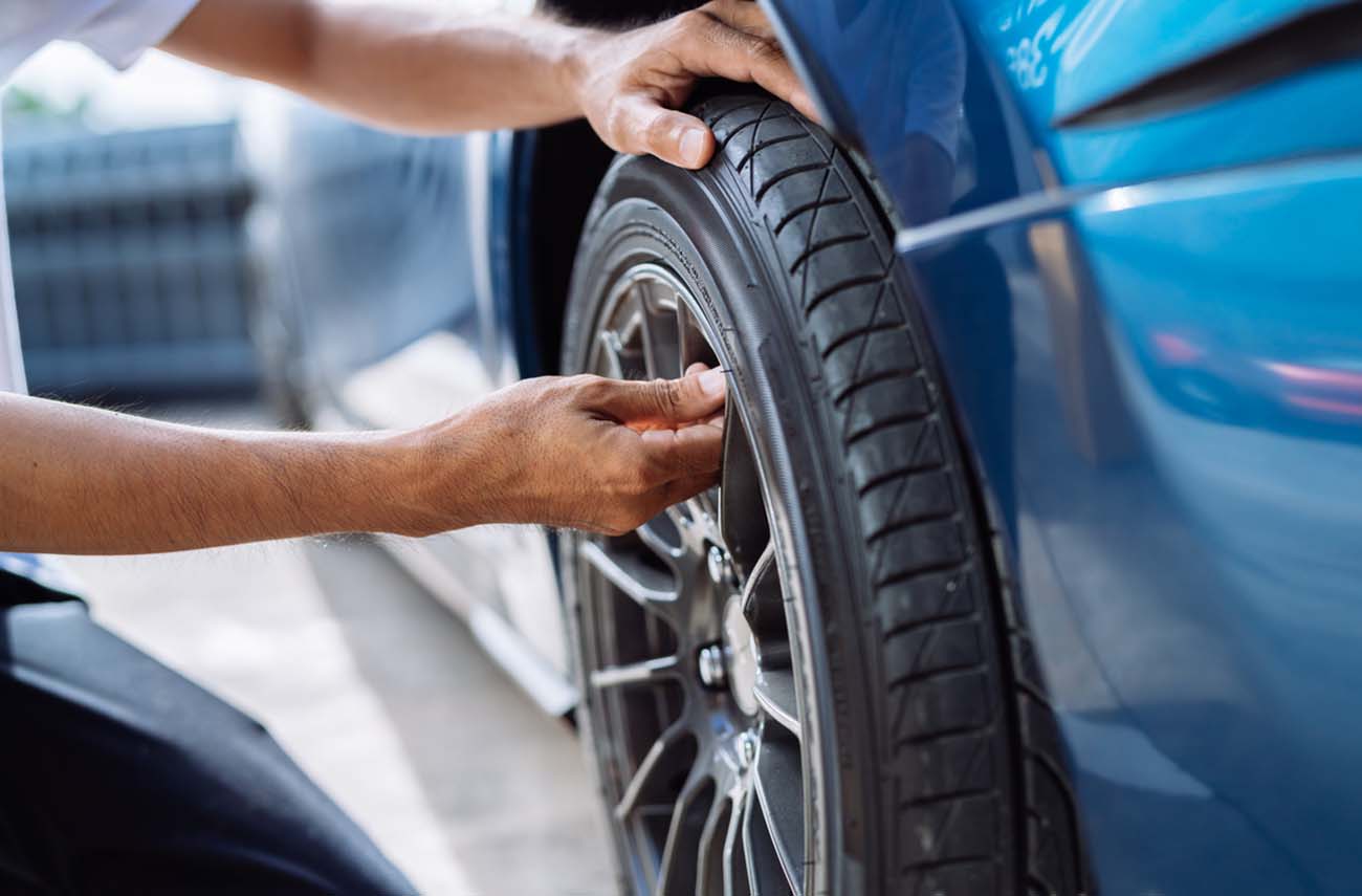 Maintenance male checking and removing tire valve filling nitrogen service on street at gas station, Safety vehicle to reduce accidents before a long travel, Blue car of man transportation lifestyle