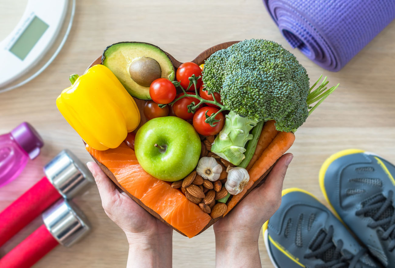 Healthy lifestyle on ketogenic diet, eating clean keto food good health dietary in heart dish with aerobic body exercise, gym workout training class , weight scale and sports shoes in fitness center