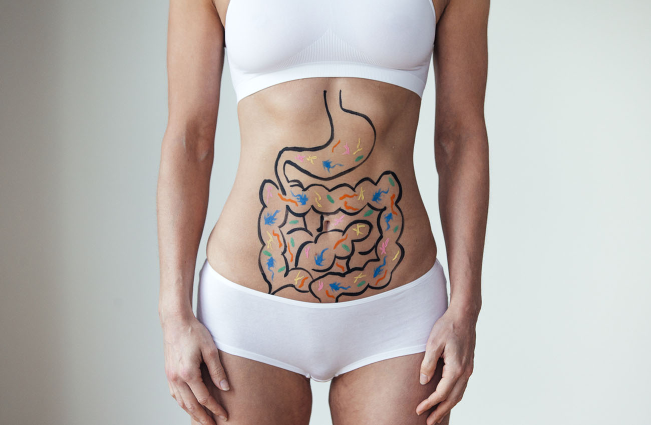 Female with an illustration on her abdomen of intestines with colourful bacteria