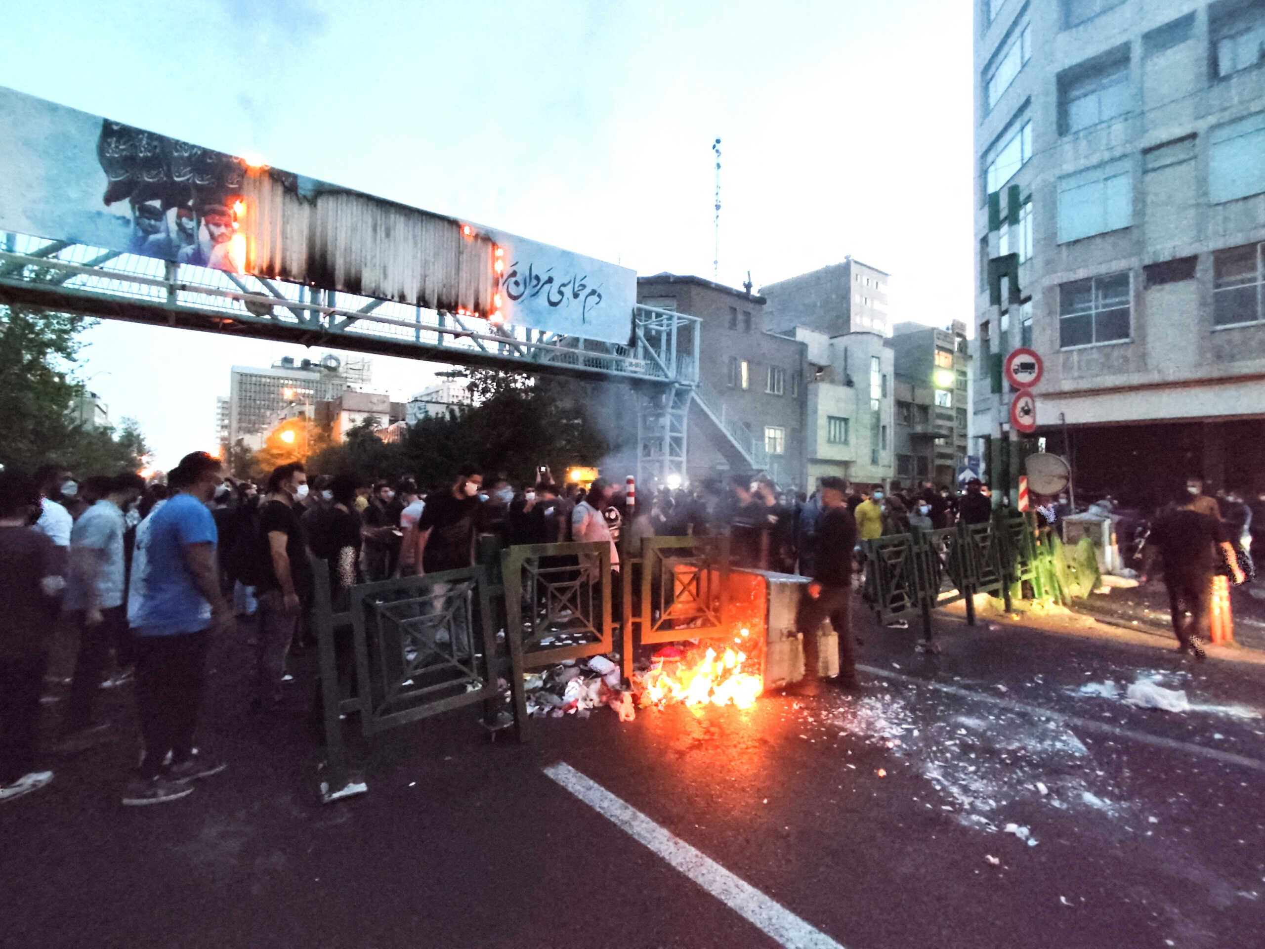 People light a fire during a protest over the death of Mahsa Amini, a woman who died after being arrested by the Islamic republic's "morality police", in Tehran, Iran September 21, 2022. WANA (West Asia News Agency) via REUTERS ATTENTION EDITORS - THIS IMAGE HAS BEEN SUPPLIED BY A THIRD PARTY. BEST QUALITY AVAILABLE DUE TO LIGHTING CONDITIONS
