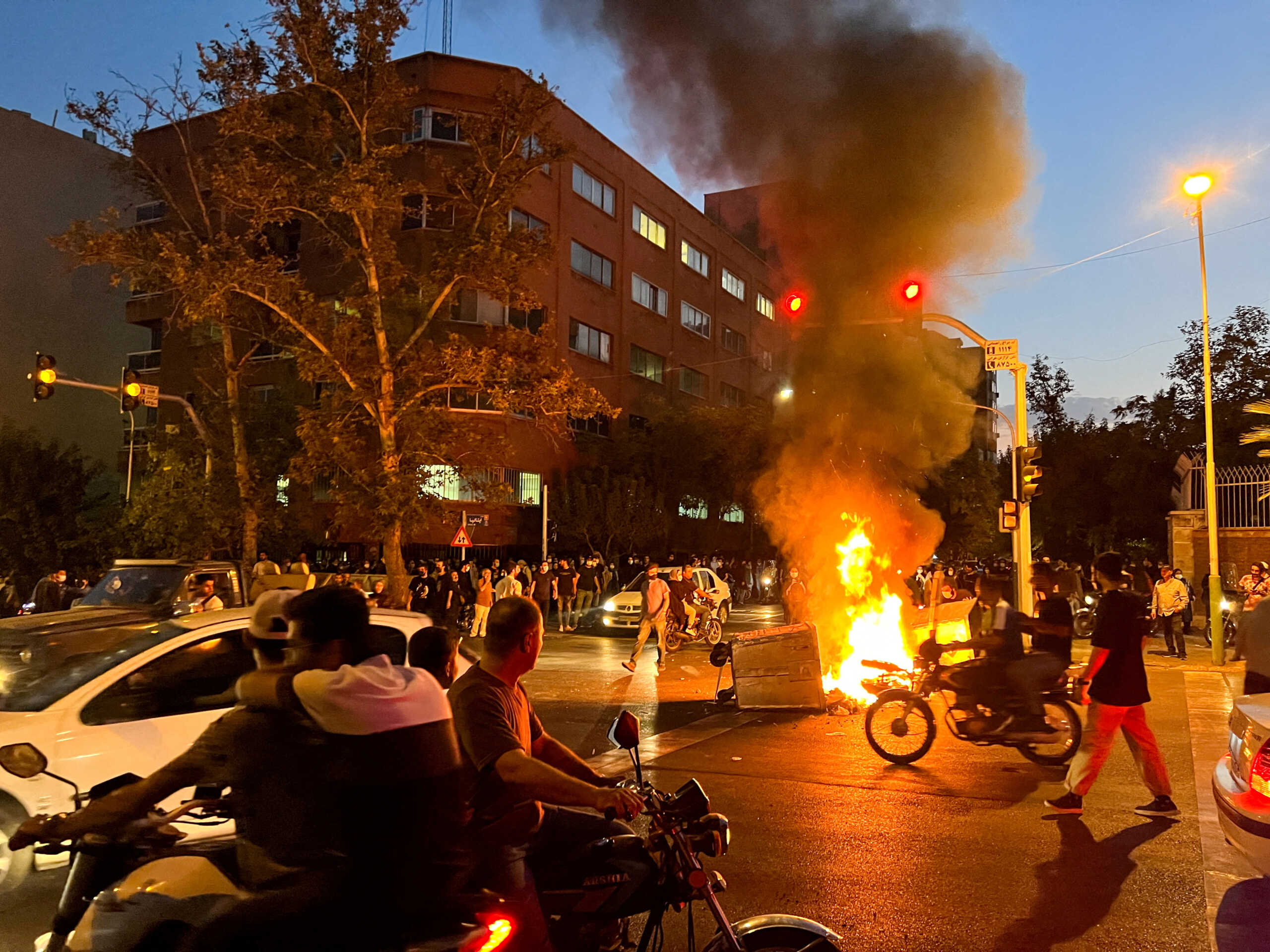 FILE PHOTO: A police motorcycle burns during a protest over the death of Mahsa Amini, a woman who died after being arrested by the Islamic republic's "morality police", in Tehran, Iran September 19, 2022. WANA (West Asia News Agency) via REUTERS