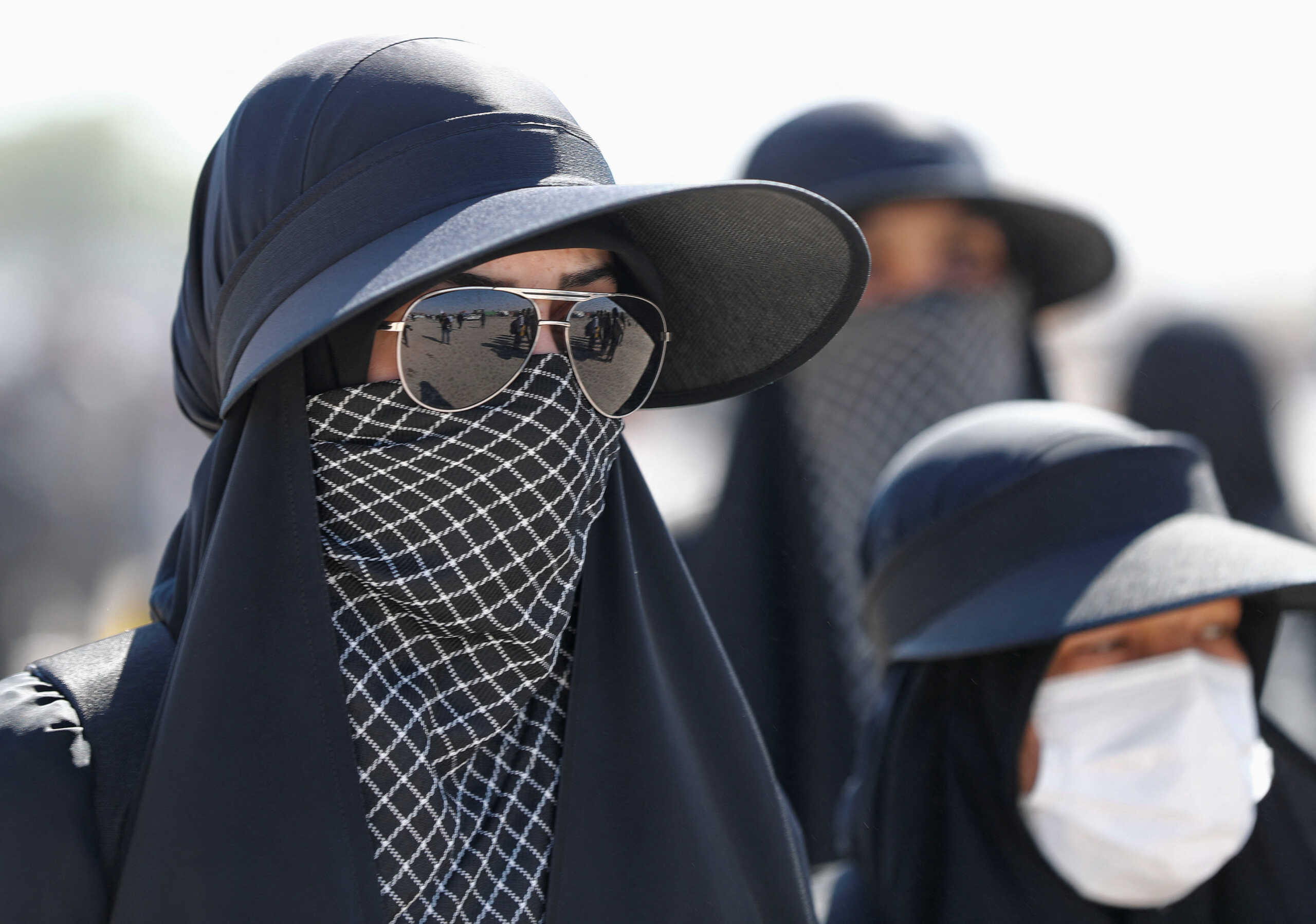 Iranian Shi'ite pilgrims walk on a road after entering Iraq through the Zurbatia border crossing between Iran and Iraq, as they head towards Iraq's holy city of Kerbala to attend the holy Shi'ite ritual of Arbaeen, in Zurbatia, Iraq September 12, 2022. REUTERS