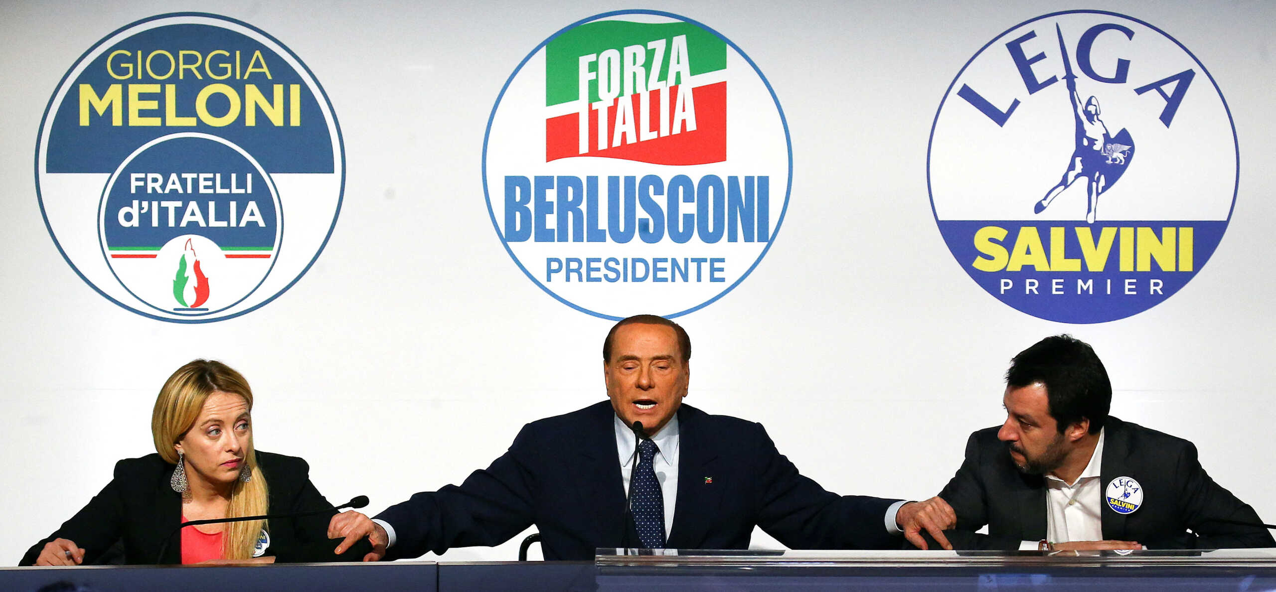 FILE PHOTO: Forza Italia leader Silvio Berlusconi speaks flanked by Fratelli D'Italia party leader Giorgia Meloni and Northern League leader Matteo Salvini during a meeting in Rome, Italy, March 1, 2018. REUTERS