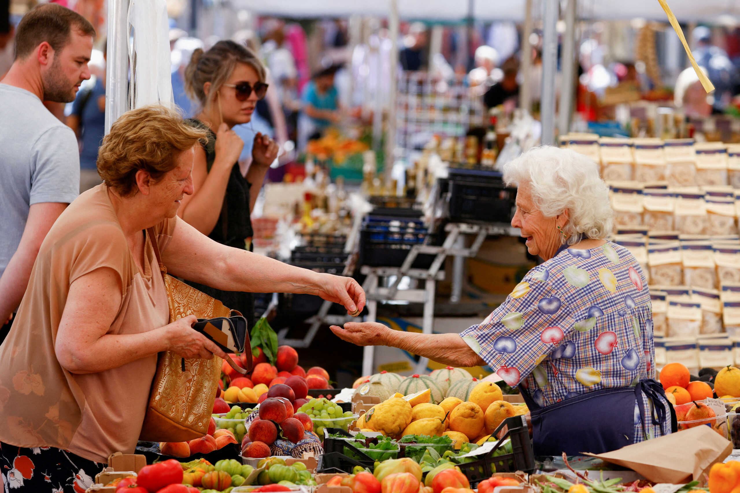 FILE PHOTO: A woman shops at Campo de' Fiori market in Rome, Italy, June 15, 2022. REUTERS