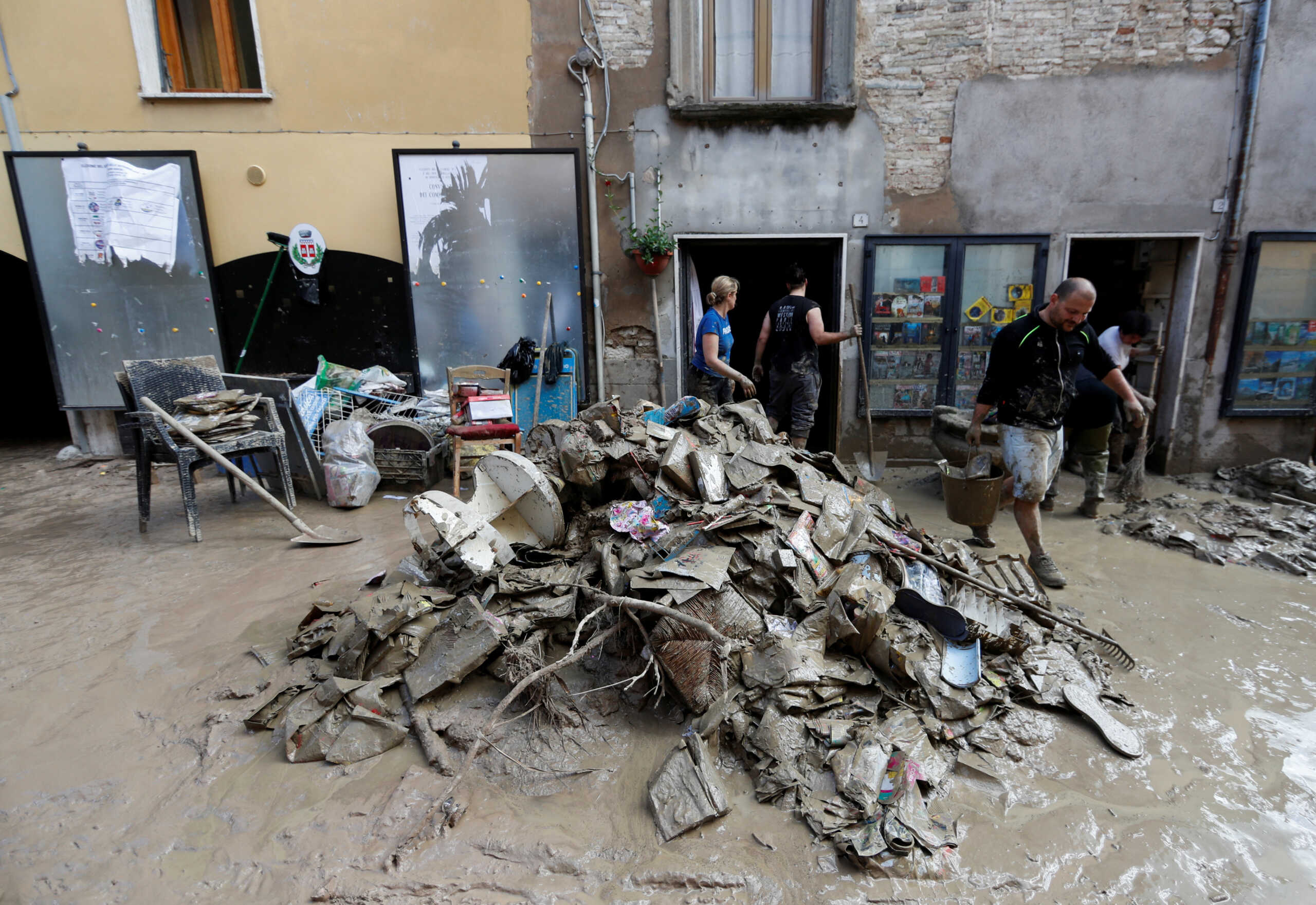 People work to clear way after heavy rains and deadly floods hit the central Italian region of Marche, in Cantiano, Italy, September 16, 2022. REUTERS