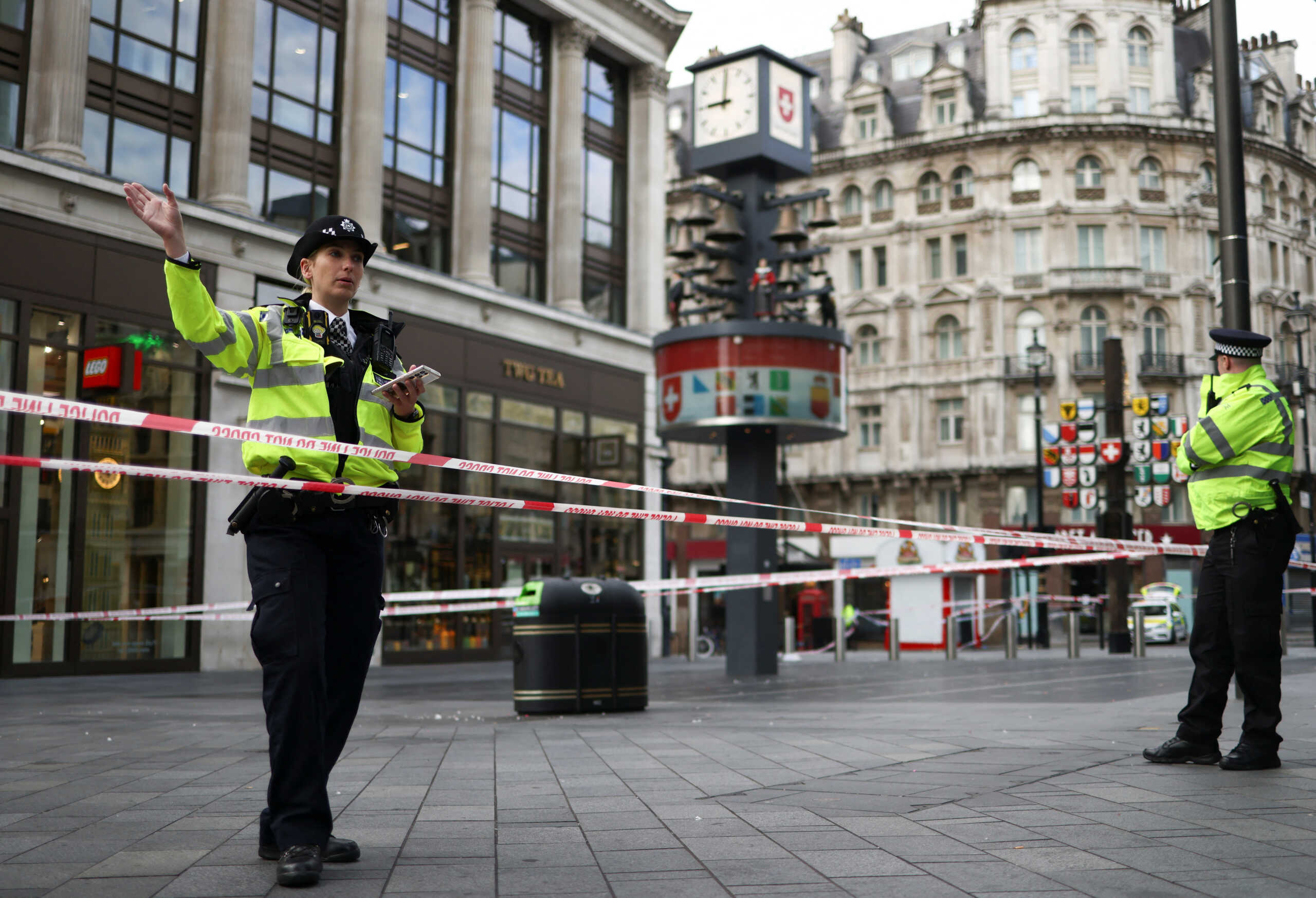 A police officer gestures at the scene where two policemen were stabbed, near Leicester Square, in London, Britain September 16, 2022. REUTERS