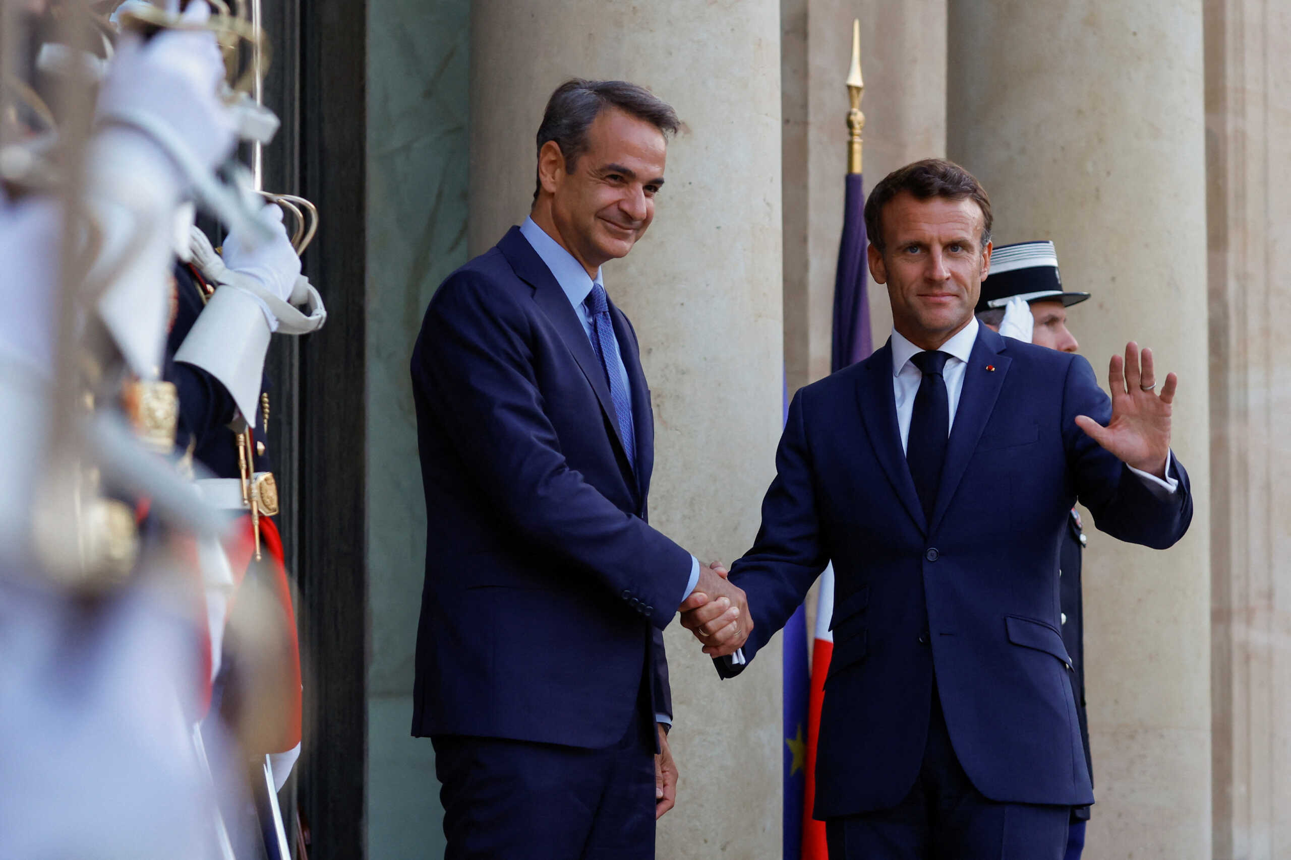 French President Emmanuel Macron welcomes Greek Prime Minister Kyriakos Mitsotakis as he arrives at the Elysee Palace in Paris, September 12, 2022. REUTERS