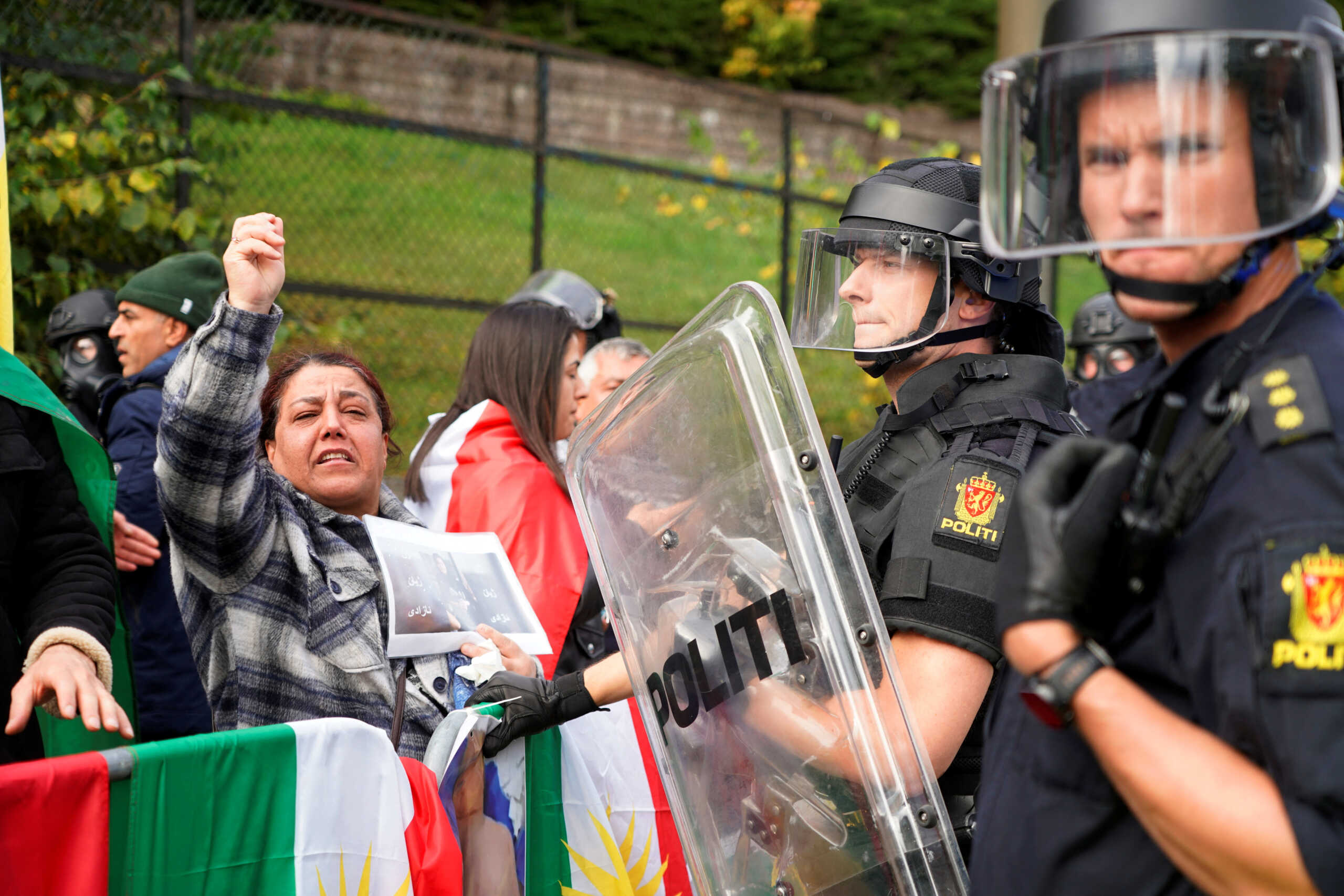 Police officers stand guard as people attend a demonstration at Iran's embassy in Oslo, Norway, September 29, 2022. NTB