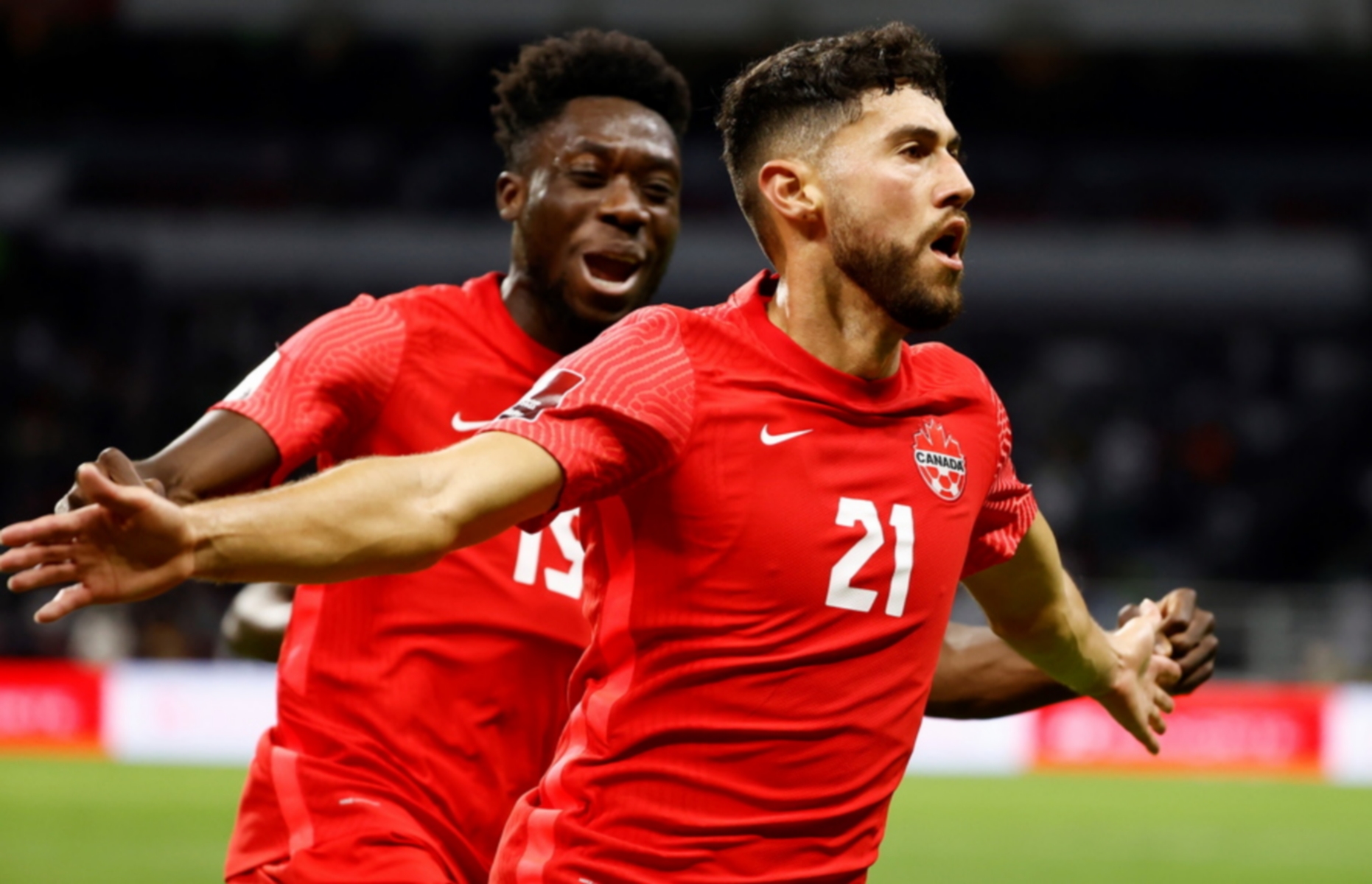 epa09512446 Jonathan Osorio (R) of Canada celebrates a goal during a CONCACAF qualifiers soccer match for Qatar 2022 World Cup between Mexico and Canada at Azteca stadium in Mexico City, Mexico, 07 October 2021.  EPA