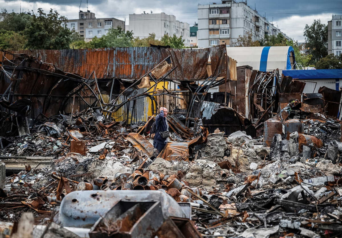 A local resident walks by a street market destroyed by military strikes, as Russia's invasion of Ukraine continues, in Saltivka, one of the most damaged residential areas of Kharkiv, Ukraine September 6, 2022.  REUTERS