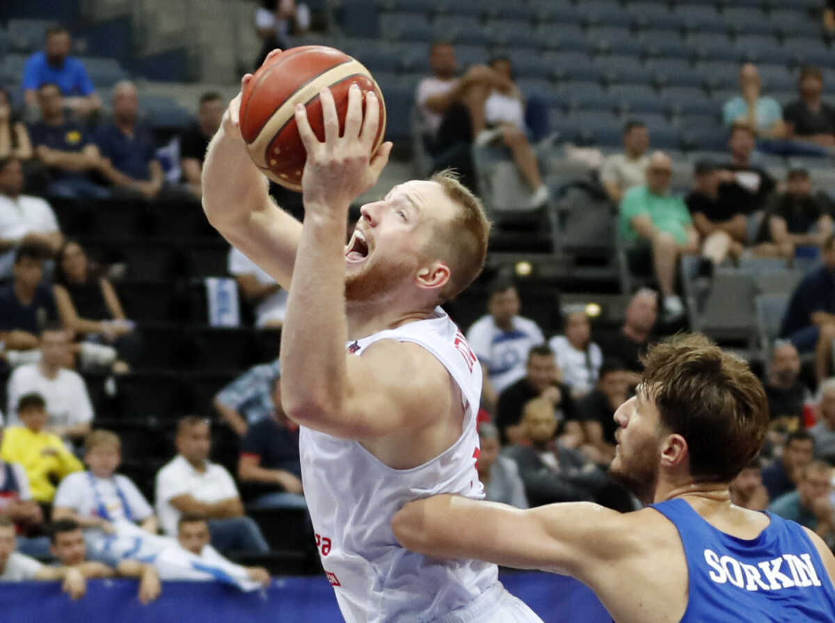 Basketball - EuroBasket Championship - Group D - Poland v Israel - Prague Arena, Prague, Czech Republic - September 5, 2022 Poland's Aleksander Dziewa in action with Israel's Roman Sorkin REUTERS