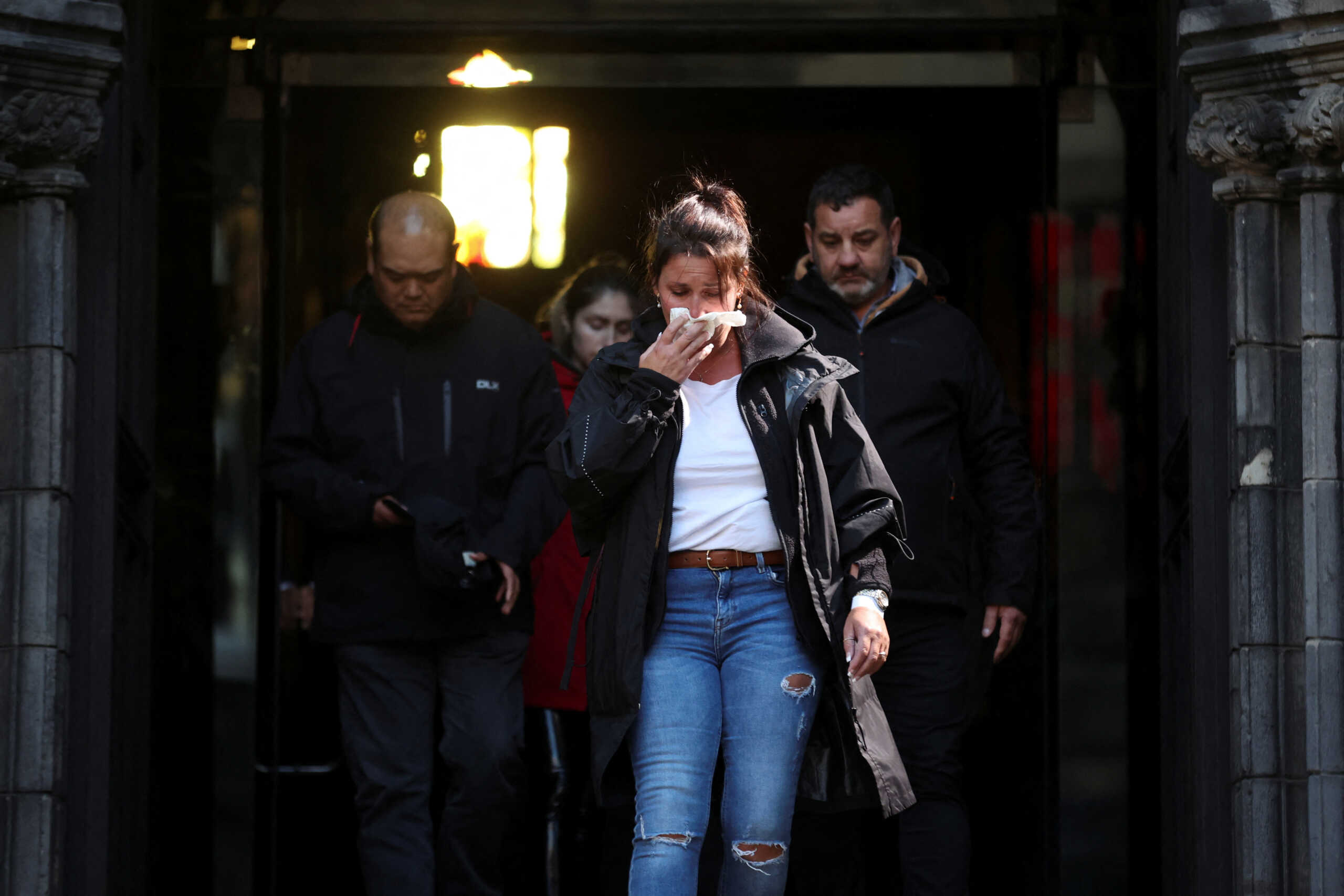 People react as they leave St. Giles' Cathedral after paying respects to Britain's Queen Elizabeth, following her death, in Edinburgh, Scotland, Britain September 12, 2022. REUTERS