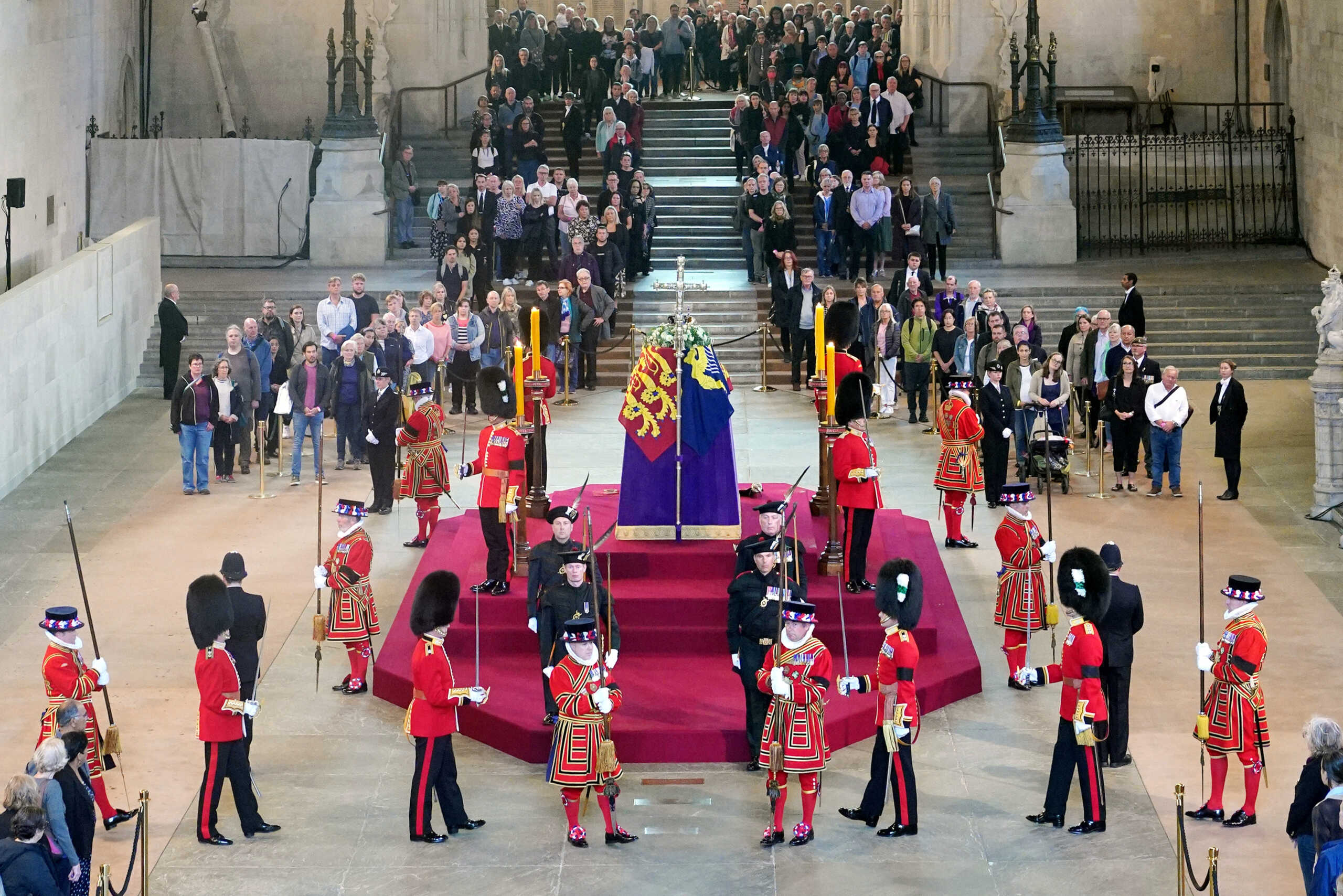 Members of the public file past the coffin of Queen Elizabeth II, draped in the Royal Standard with the Imperial State Crown and the Sovereign's orb and sceptre, lying in state on the catafalque in Westminster Hall, at the Palace of Westminster, London, ahead of her funeral on Monday. Picture date: Thursday September 15, 2022.    Yui Mok