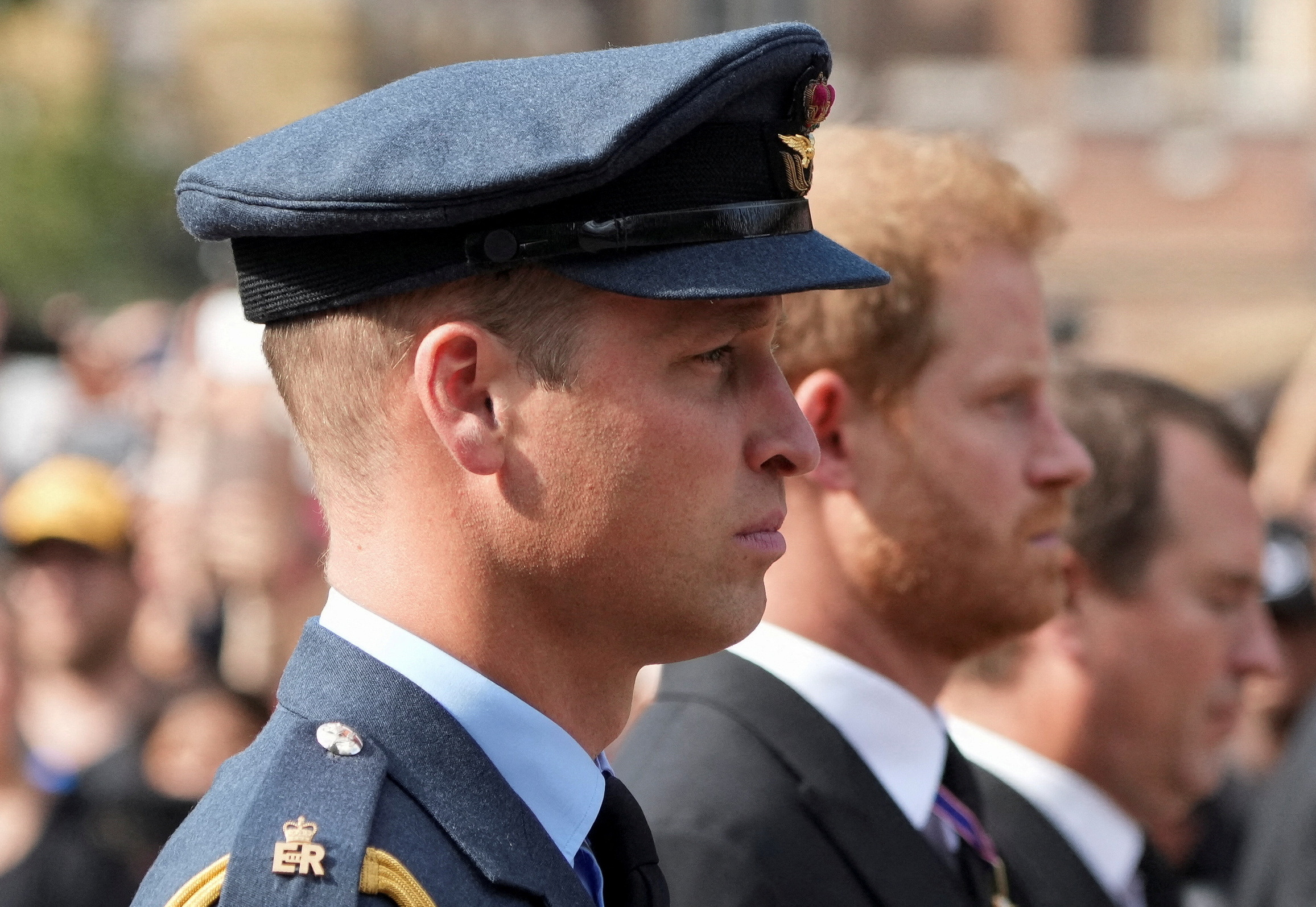Britain's William, Prince of Wales, and Prince Harry march during the procession of the coffin of Britain's Queen Elizabeth from Buckingham Palace to the Houses of Parliament for her lying in state, in London, Britain, September 14, 2022.   REUTERS