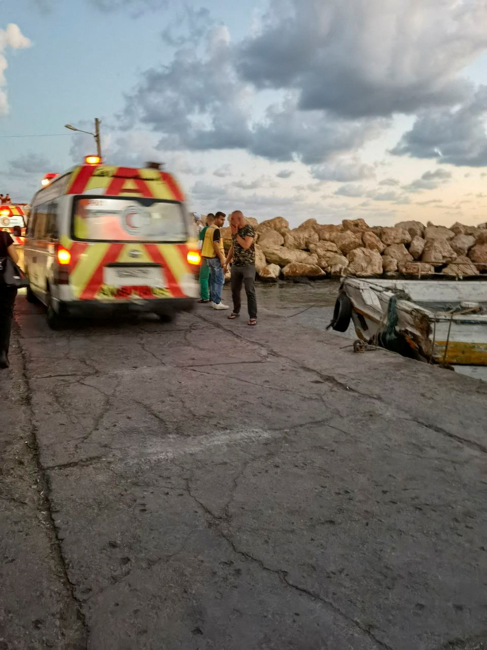 An ambulance is seen during the rescue process of migrants in the port of Tartous, Syria September 22, 2022 in this picture obtained from social media. Saleh Sliman