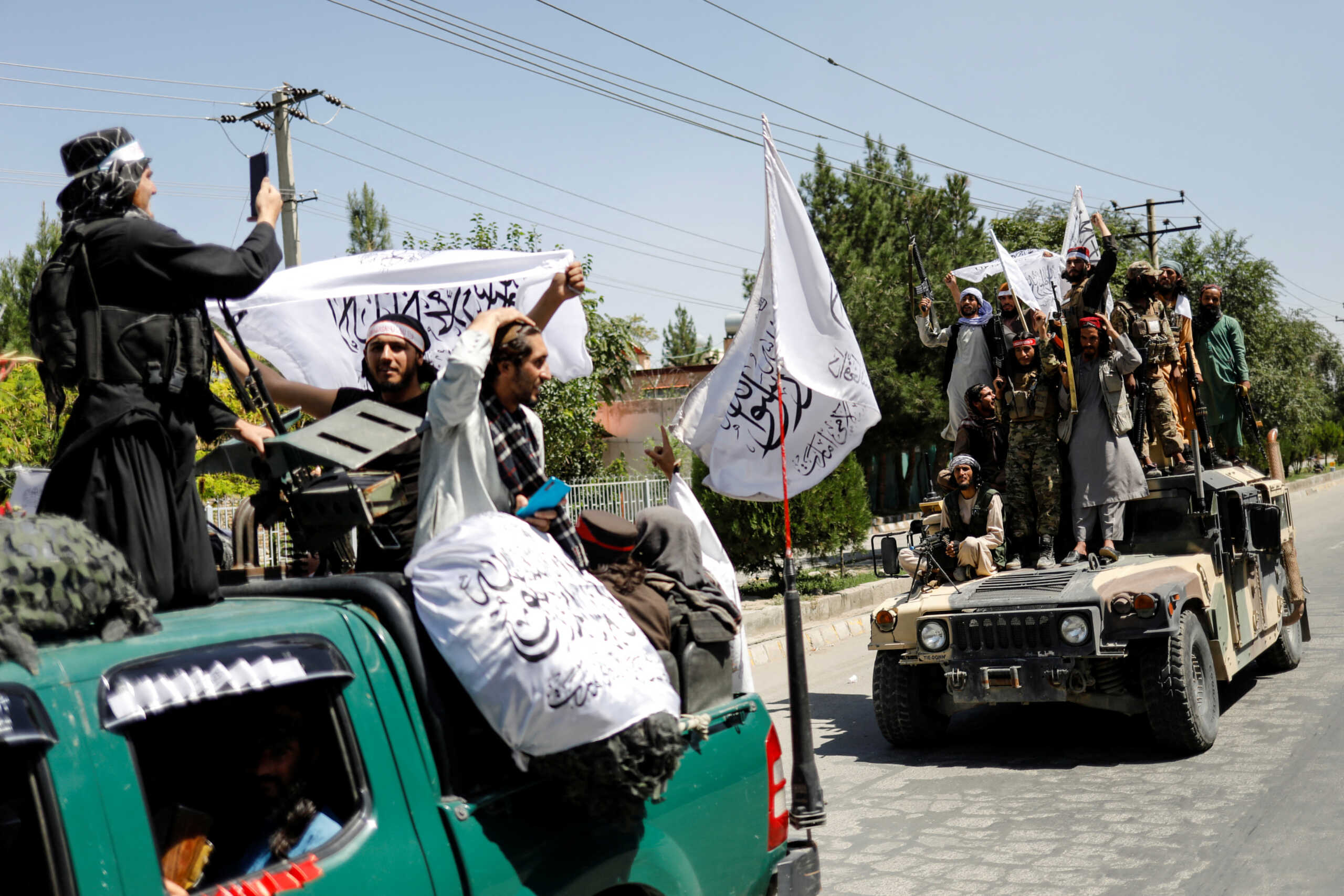 Members of the Taliban ride atop a military vehicle on the first anniversary of the withdrawal of U.S. troops from Afghanistan, on a street in Kabul, Afghanistan, August 31, 2022. REUTERS