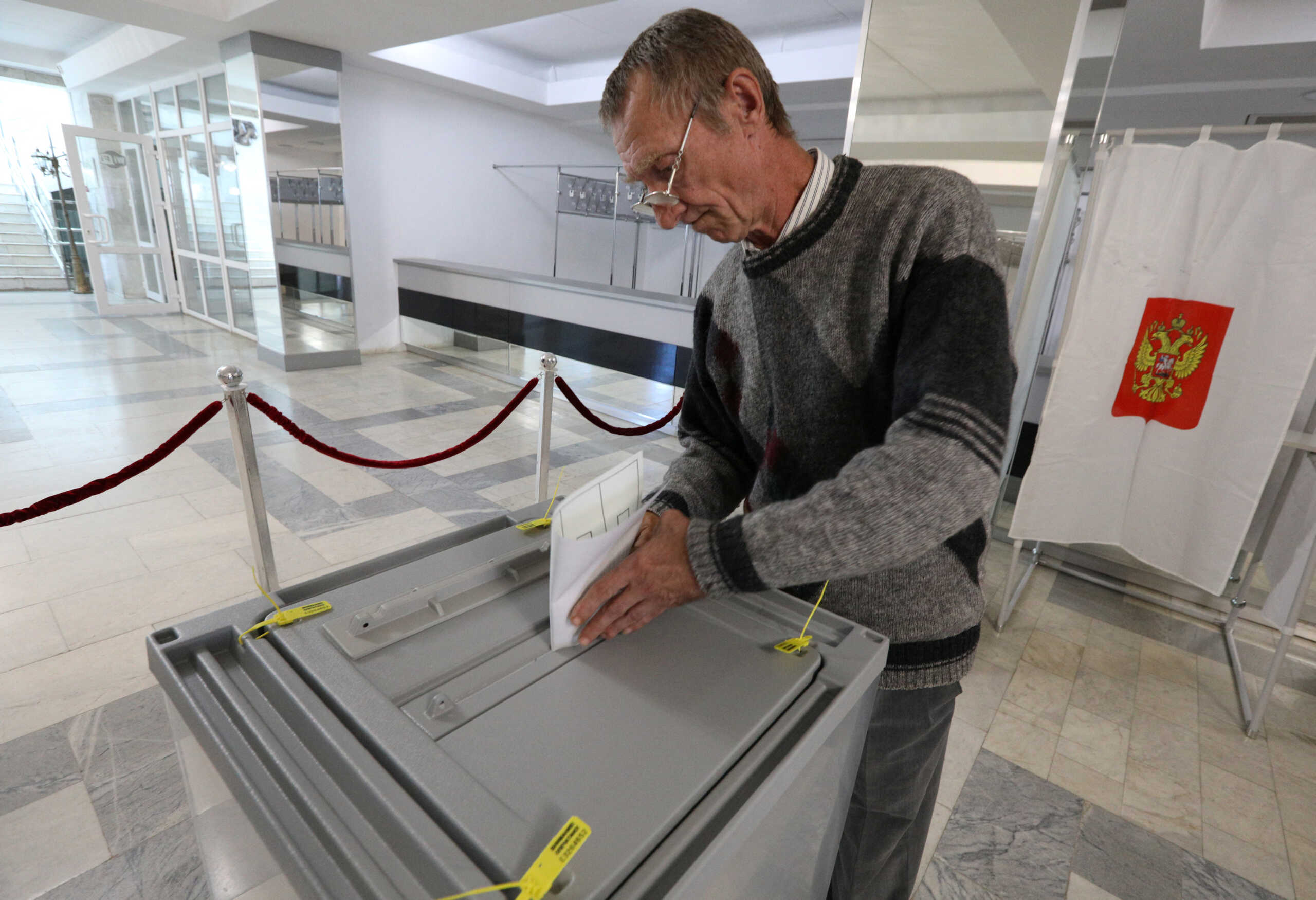 A man casts his ballot during the first day of a referendum on the joining of Russian-controlled regions of Ukraine to Russia, in Sevastopol, Crimea September 23, 2022. Voting takes place for residents of the self-proclaimed Donetsk (DPR) and Luhansk People's Republics (LPR) and Russian-controlled areas of the Kherson and Zaporizhzhia regions of Ukraine. REUTERS