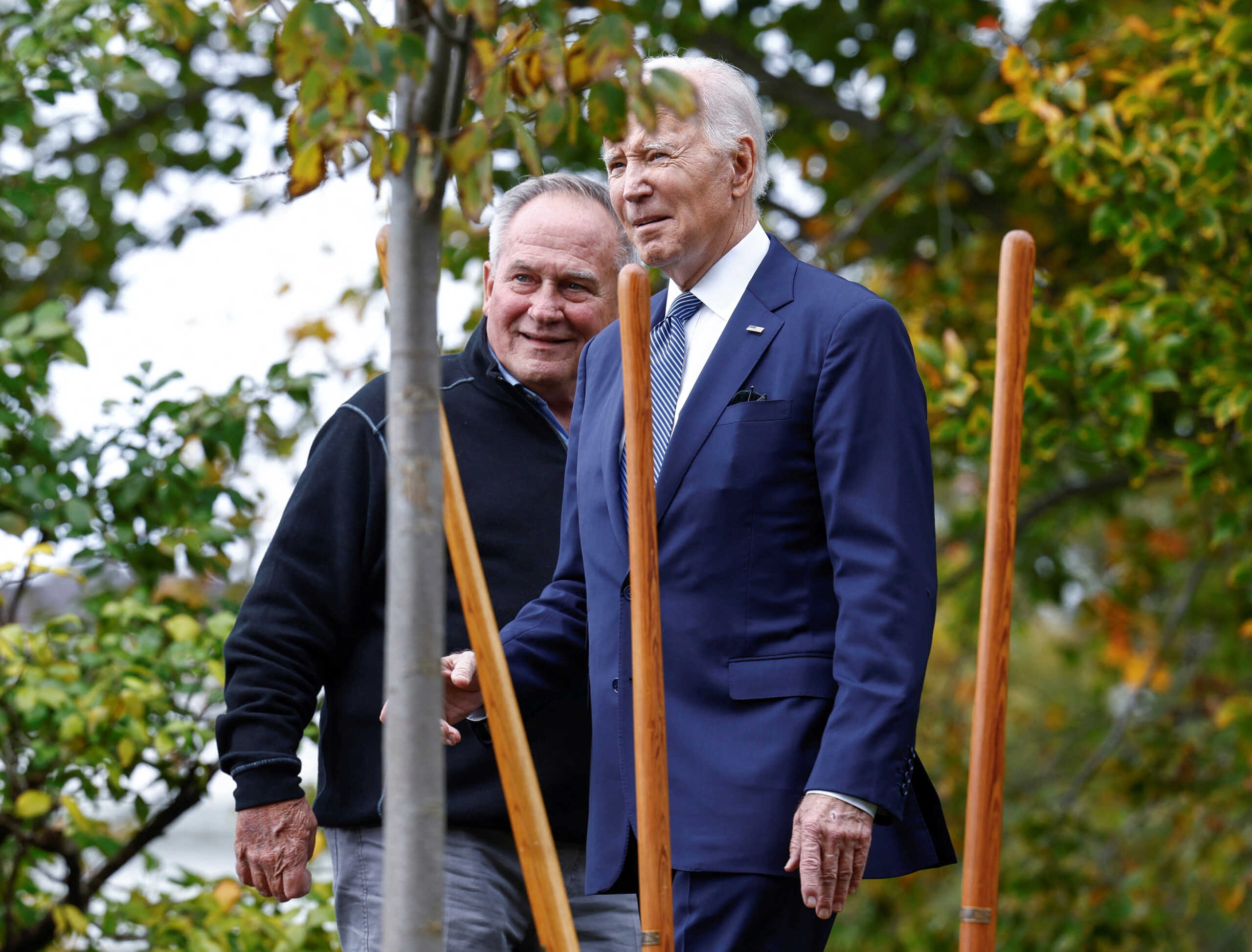 U.S. President Joe Biden plants a new elm tree on the south lawn of the White House to honor Dale Haney,  Superintendent of the White House Grounds, in Washington, U.S., October 24, 2022. REUTERS