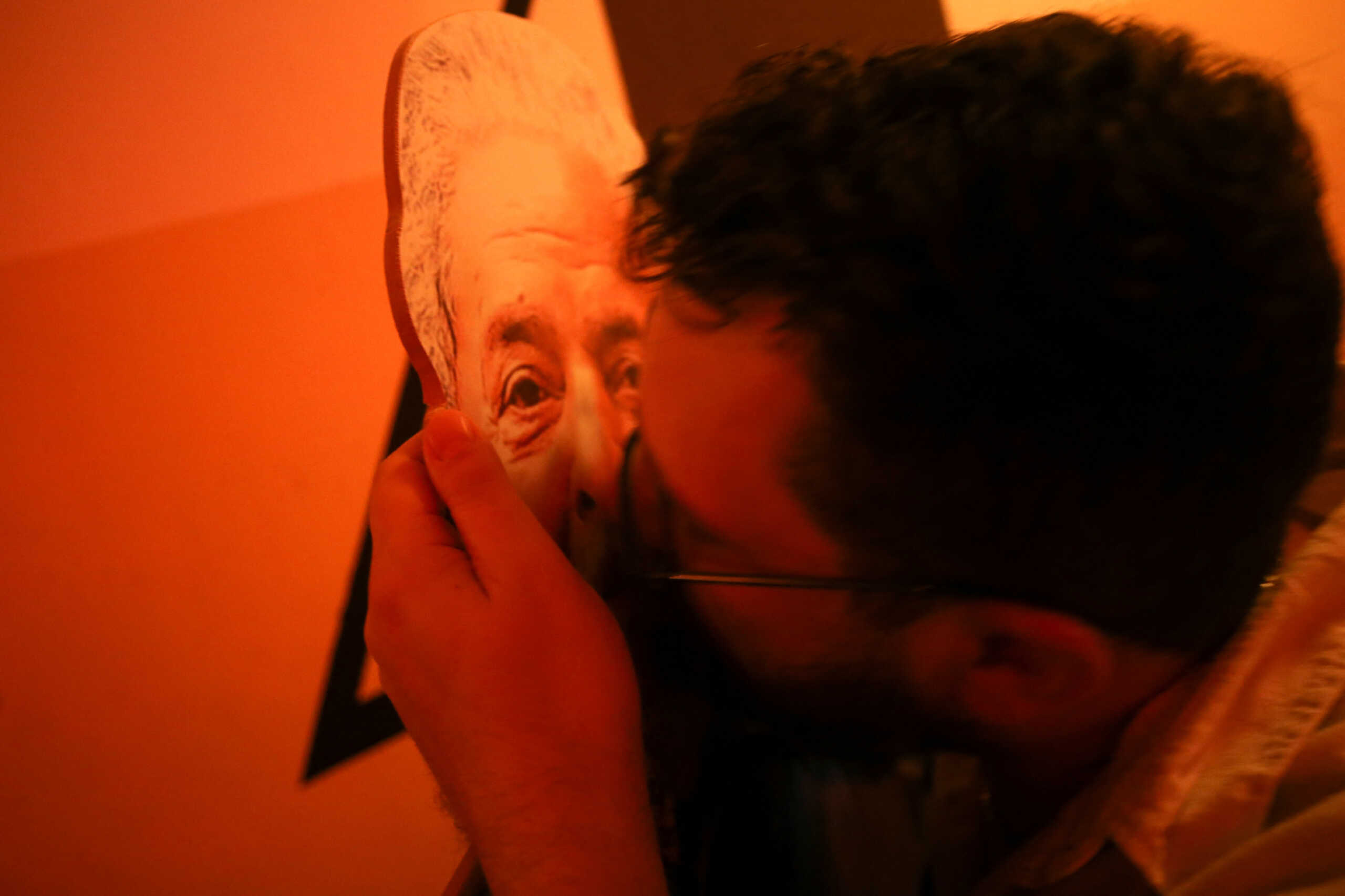 A supporter of Brazil's former president and presidential candidate Luiz Inacio Lula da Silva kisses a cutout of Lula while celebrating at a gathering for the Brazilian presidential election run-off, in Brasilia, Brazil October 31, 2022. REUTERS