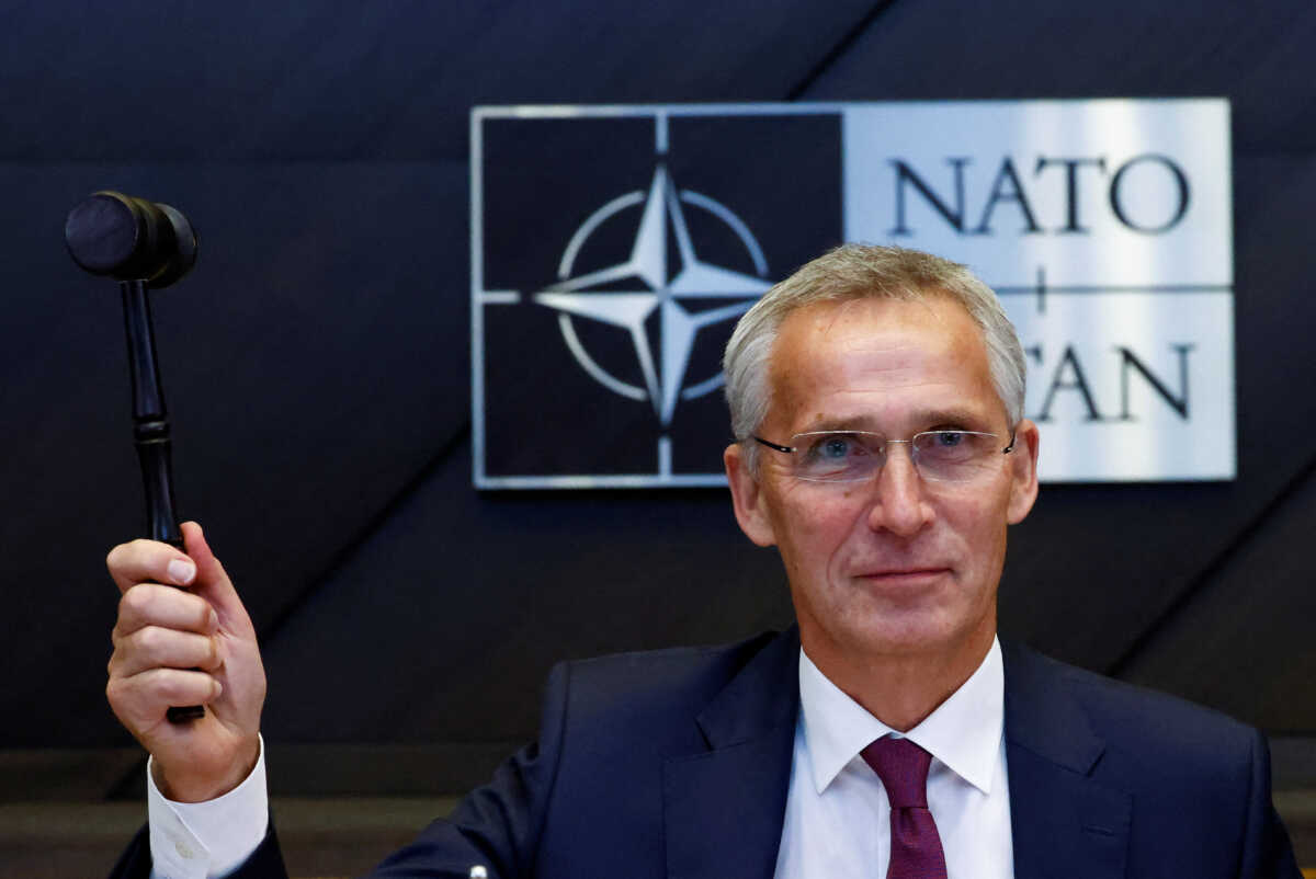 NATO Secretary General Jens Stoltenberg gestures with a hammer during a NATO defence ministers meeting, with Finland and Sweden as invitees, at the Alliance's headquarters in Brussels, Belgium October 13, 2022. REUTERS