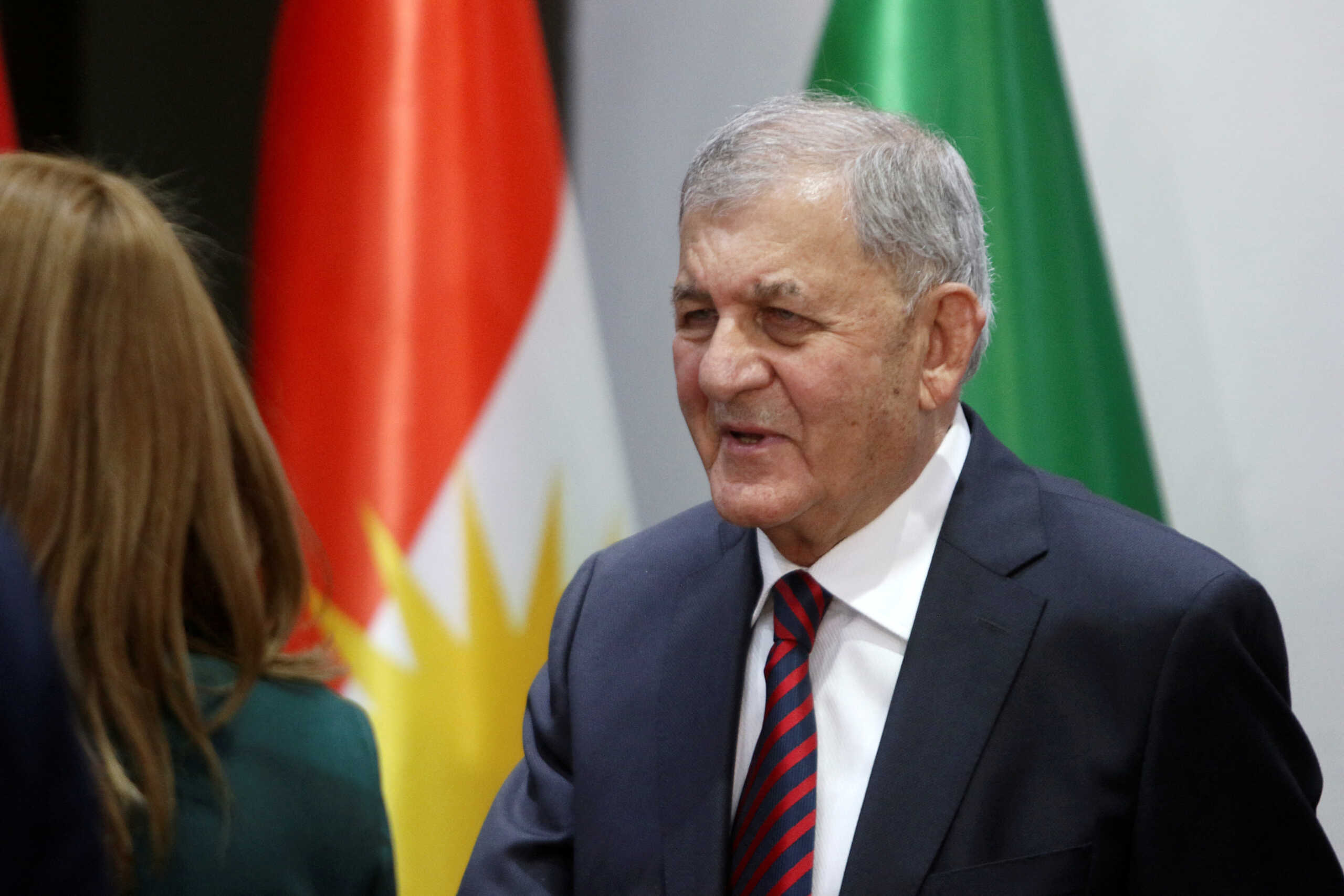 Abdul Latif Rashid, the newly elected Iraqi president, speaks with a woman, at the Iraqi parliament in Baghdad, Iraq October 13, 2022. REUTERS