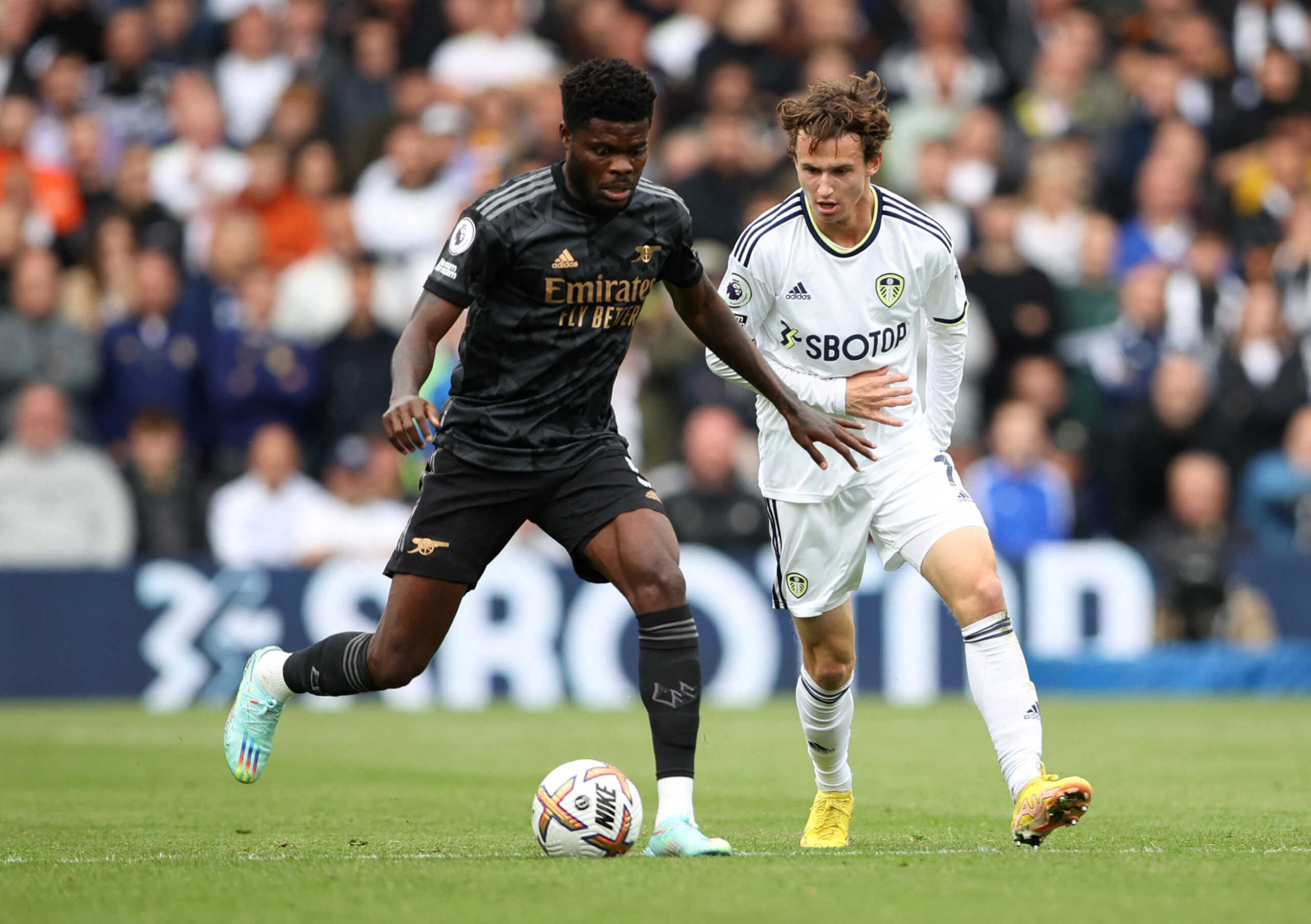 Soccer Football - Premier League - Leeds United v Arsenal - Elland Road, Leeds, Britain - October 16, 2022 Arsenal's Thomas Partey in action with Leeds United's Brenden Aaronson Action Images via Reuters